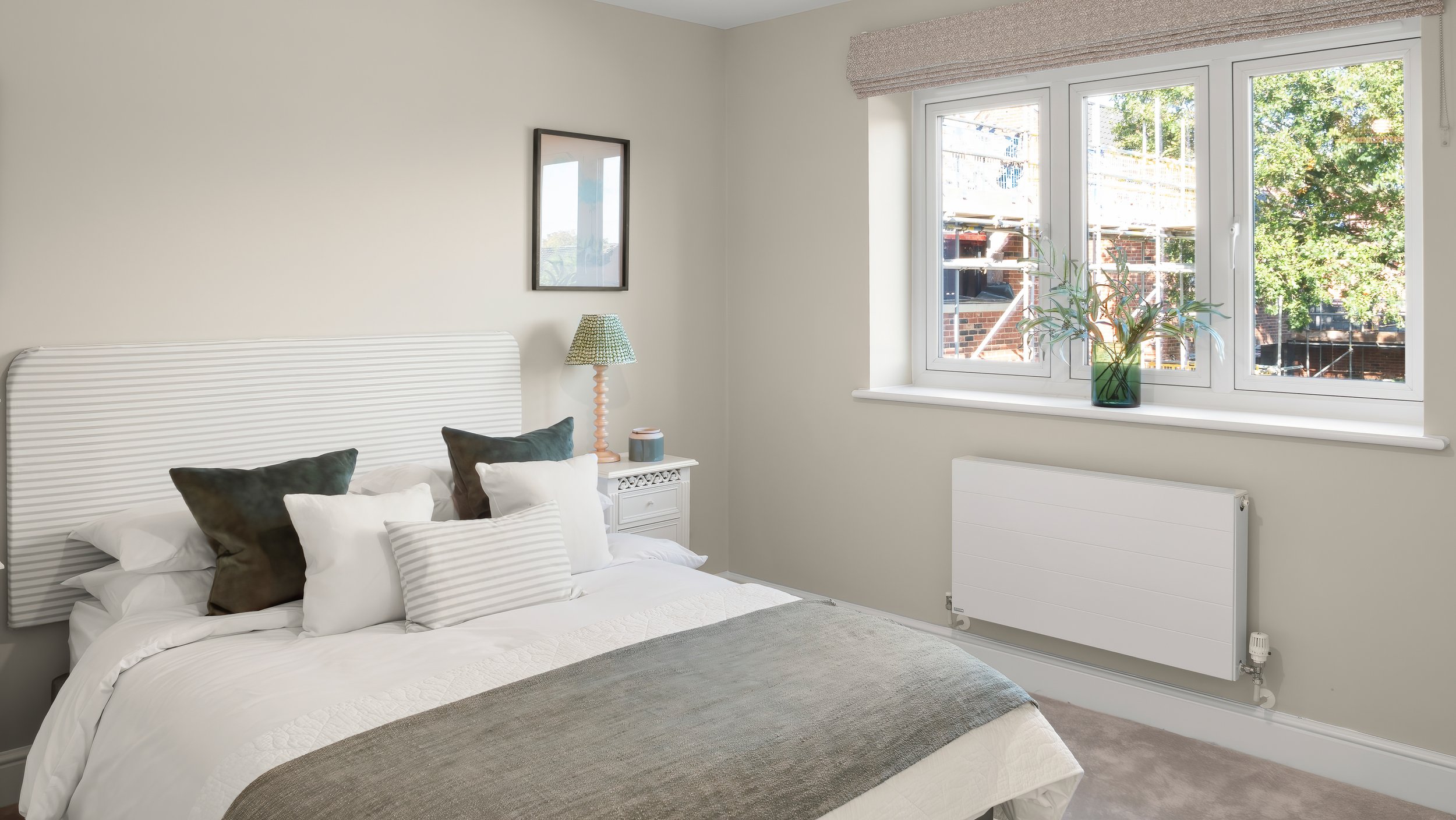 Furnished bedroom with garden-facing windows at The Green