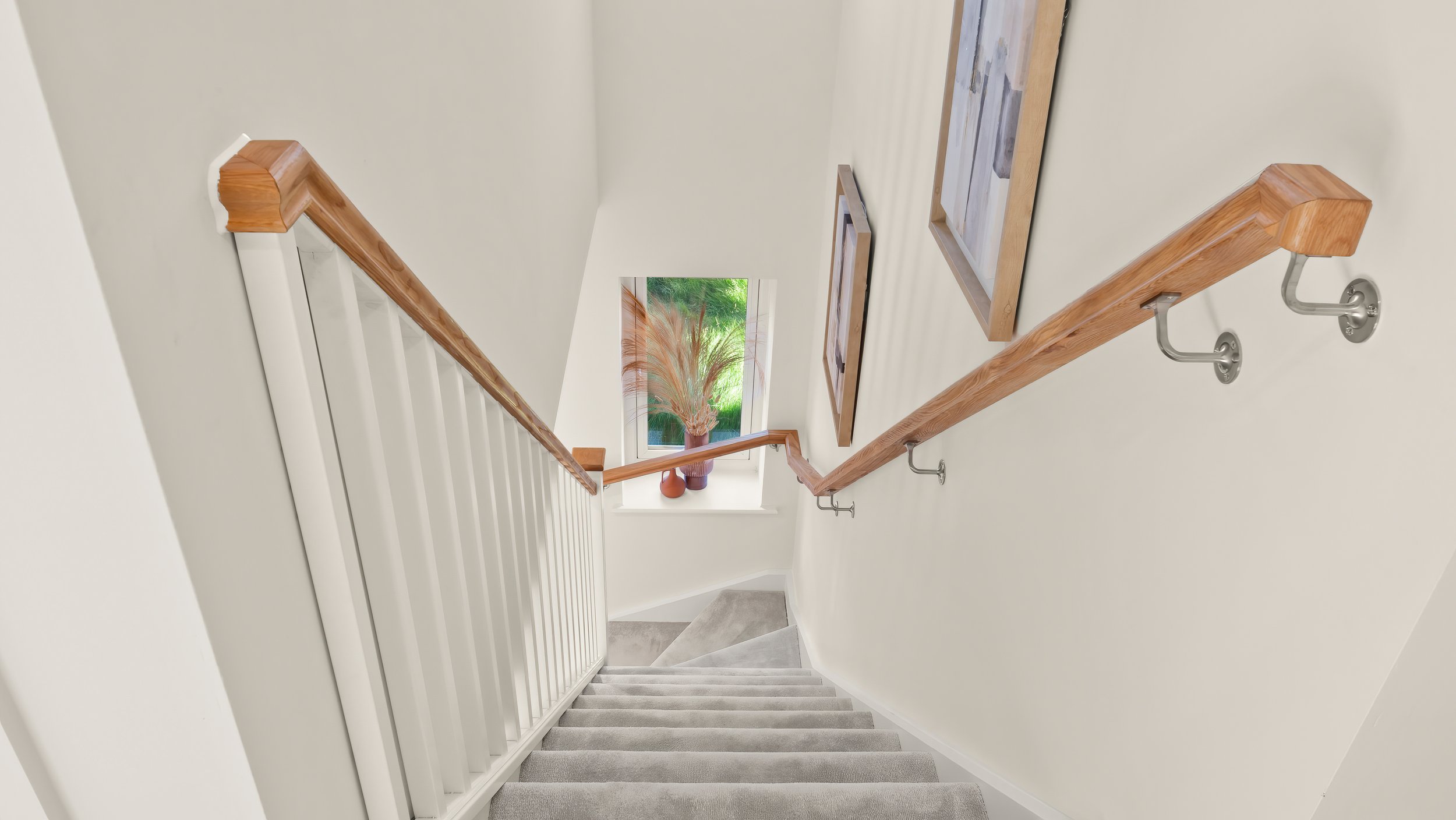 Staircase with timber handrail inside a home at The Green