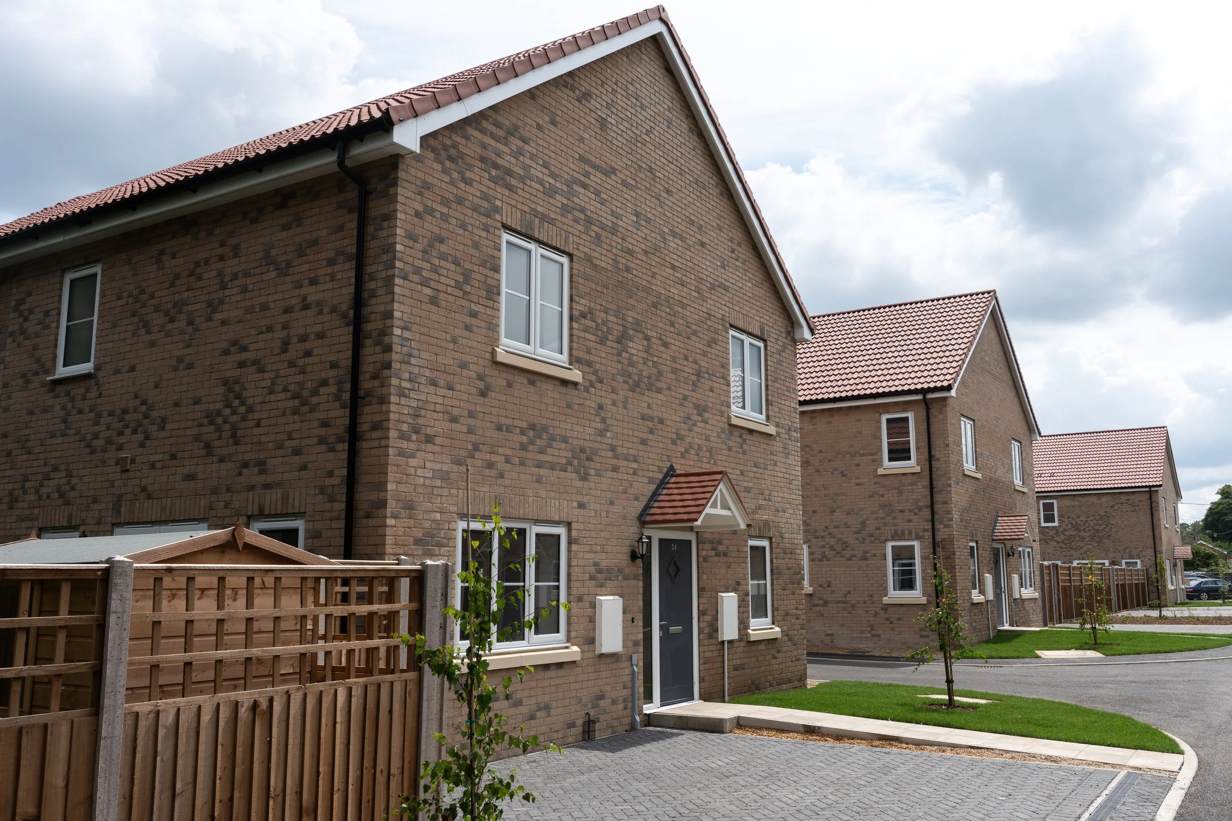 Brick homes with driveways and landscaped verges at Gowers Place
