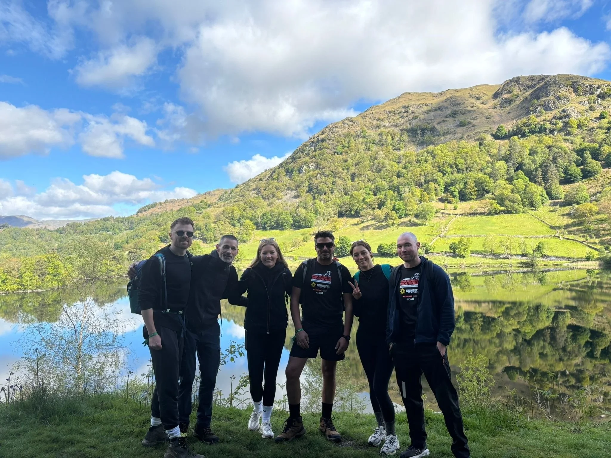 Six members of the Aspen Build team beside a lake during the Cumbria Challenge