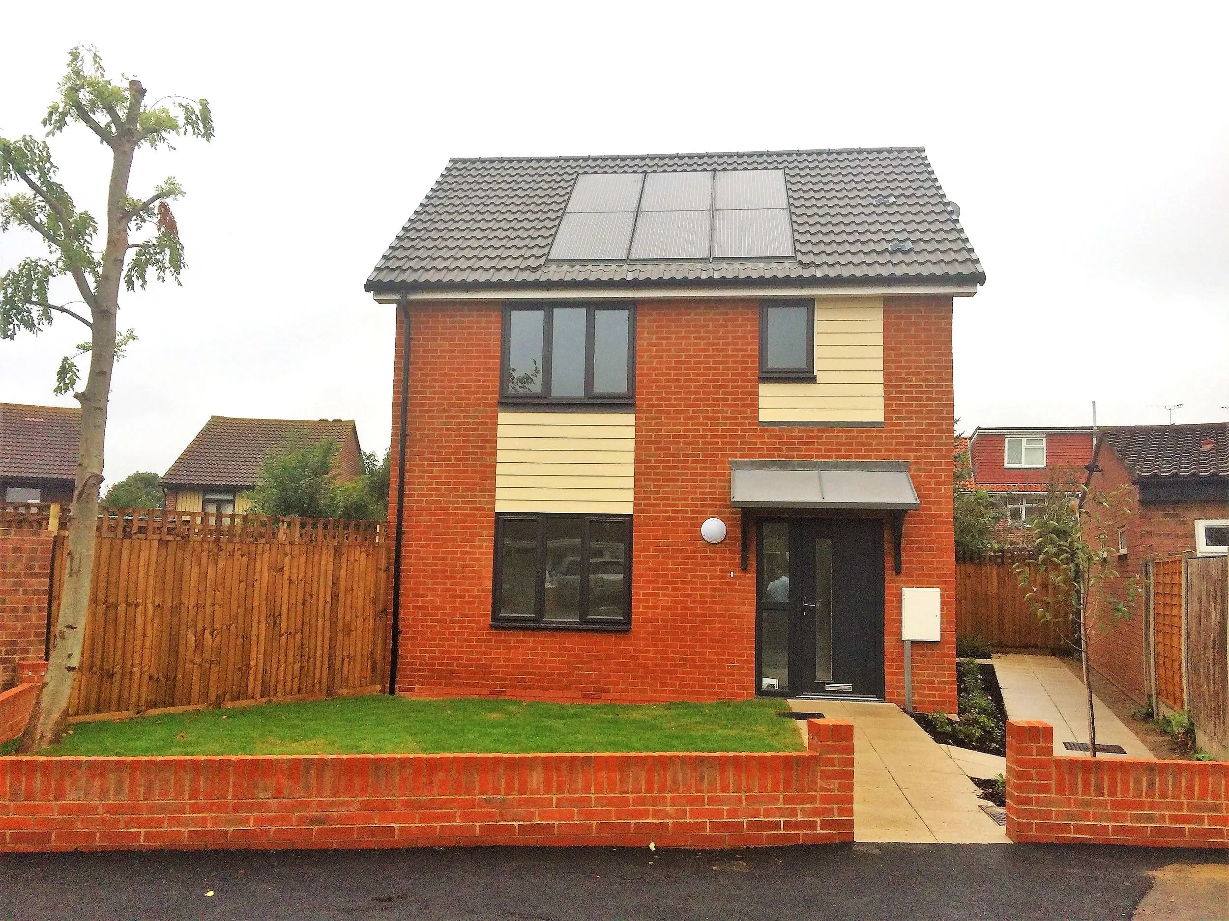 Detached brick home with roof-mounted solar panels at Northdown Gardens Phase 2