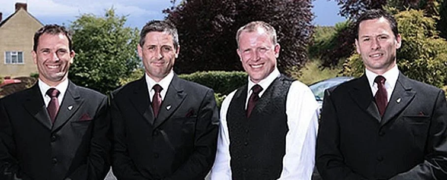 Four Thomas Brothers smiling for a photo.