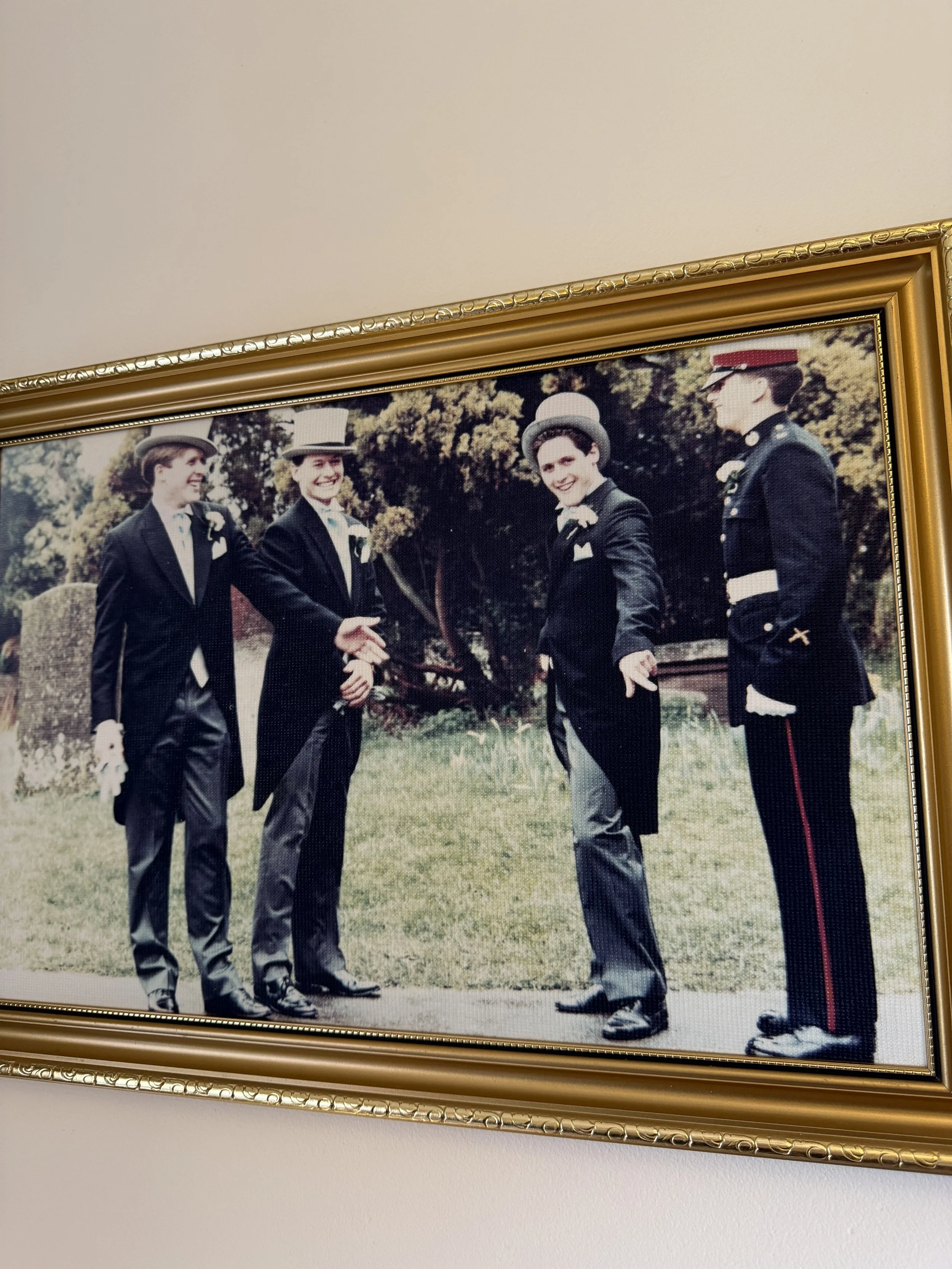 A framed photograph of four Thomas Brothers dressed in vintage attire.