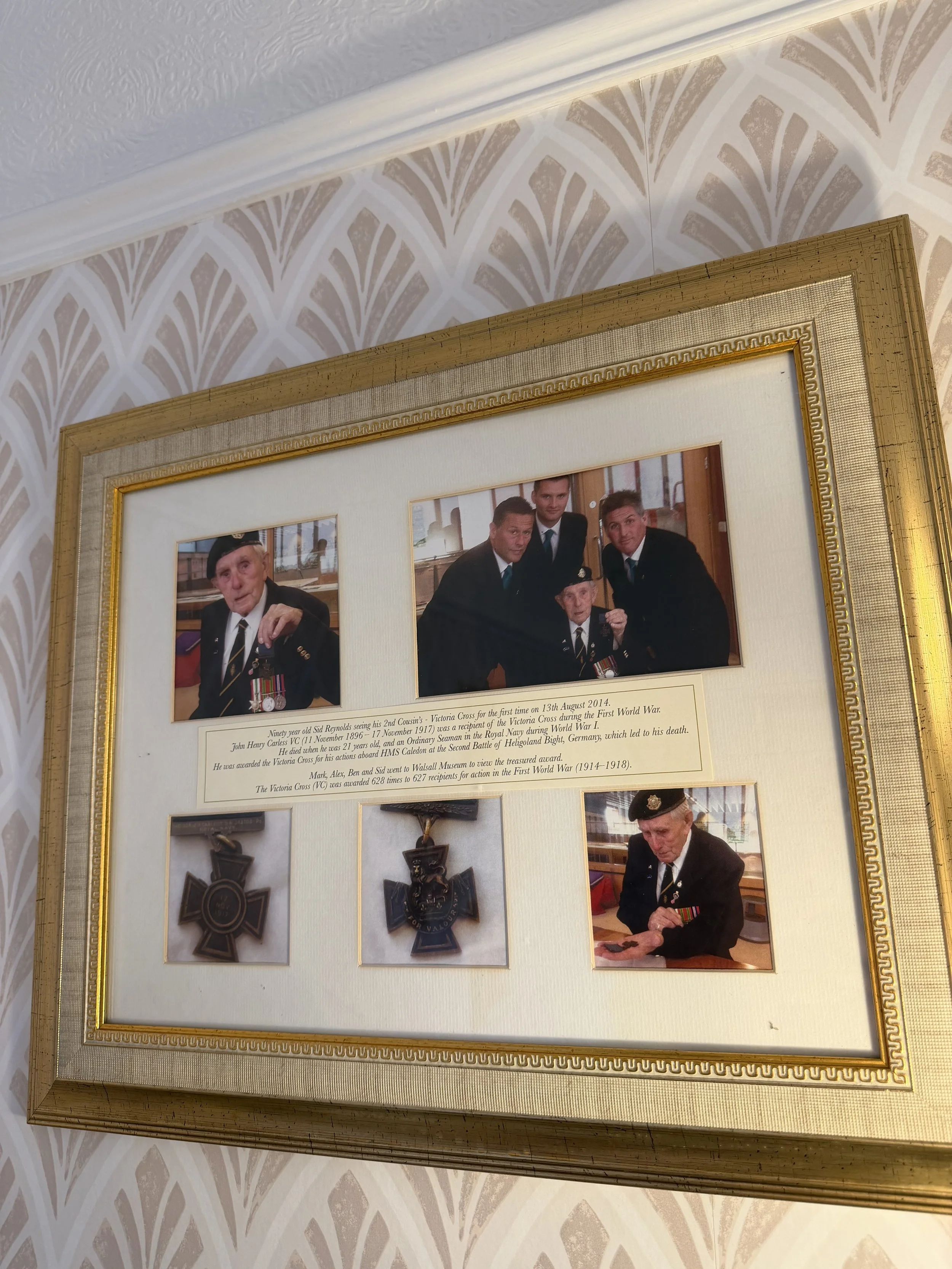 A framed collage featuring photographs of military veterans, medals, Thomas Brothers The Funeral Directors legacy.