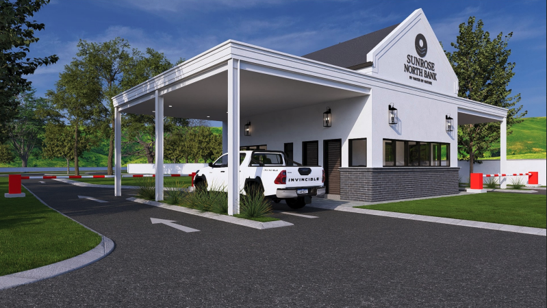 Sunrose North Bank building with a drive-thru lane, parked white pickup truck, and green landscaping.