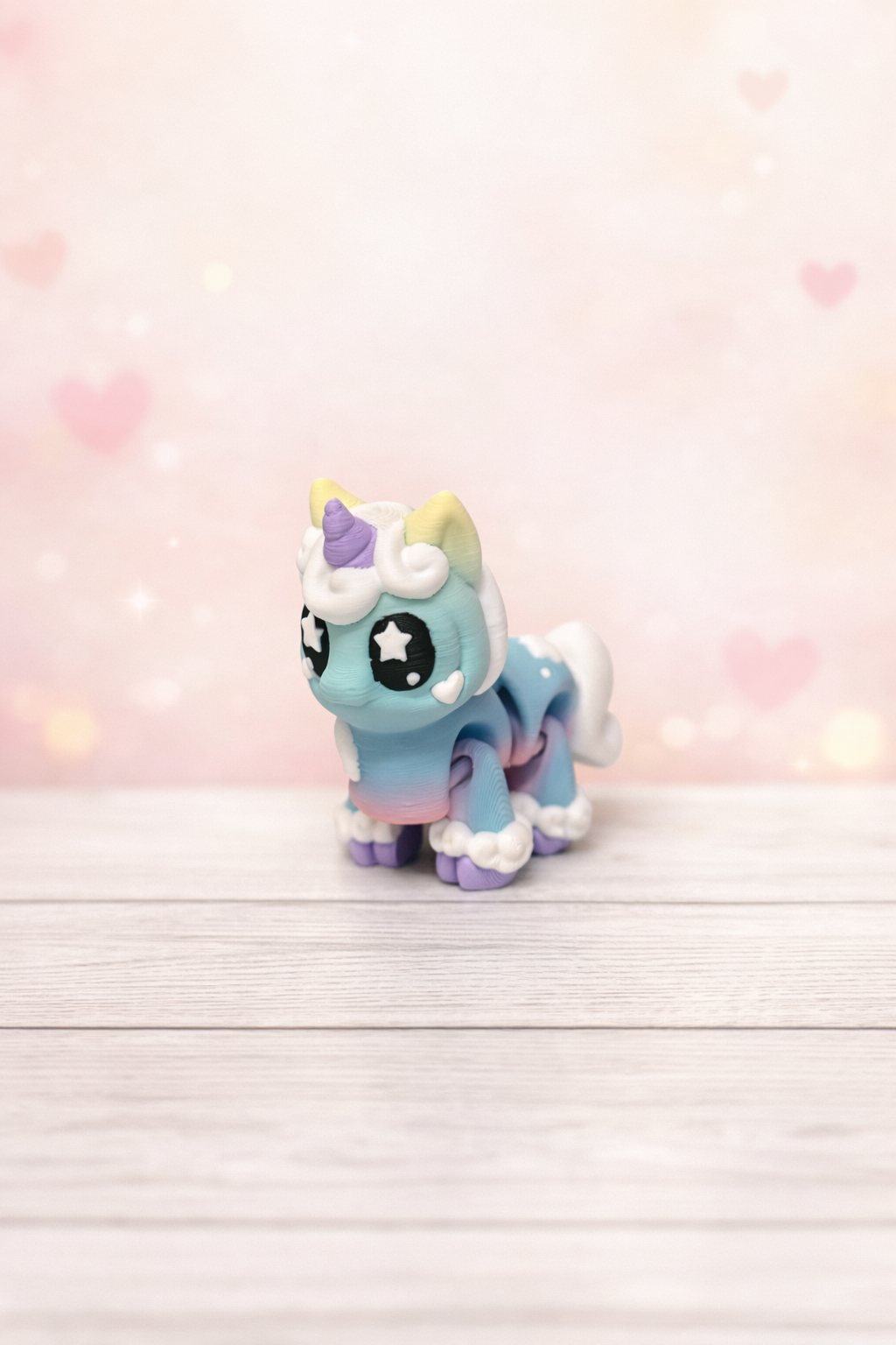 Pastel unicorn on wooden surface.png