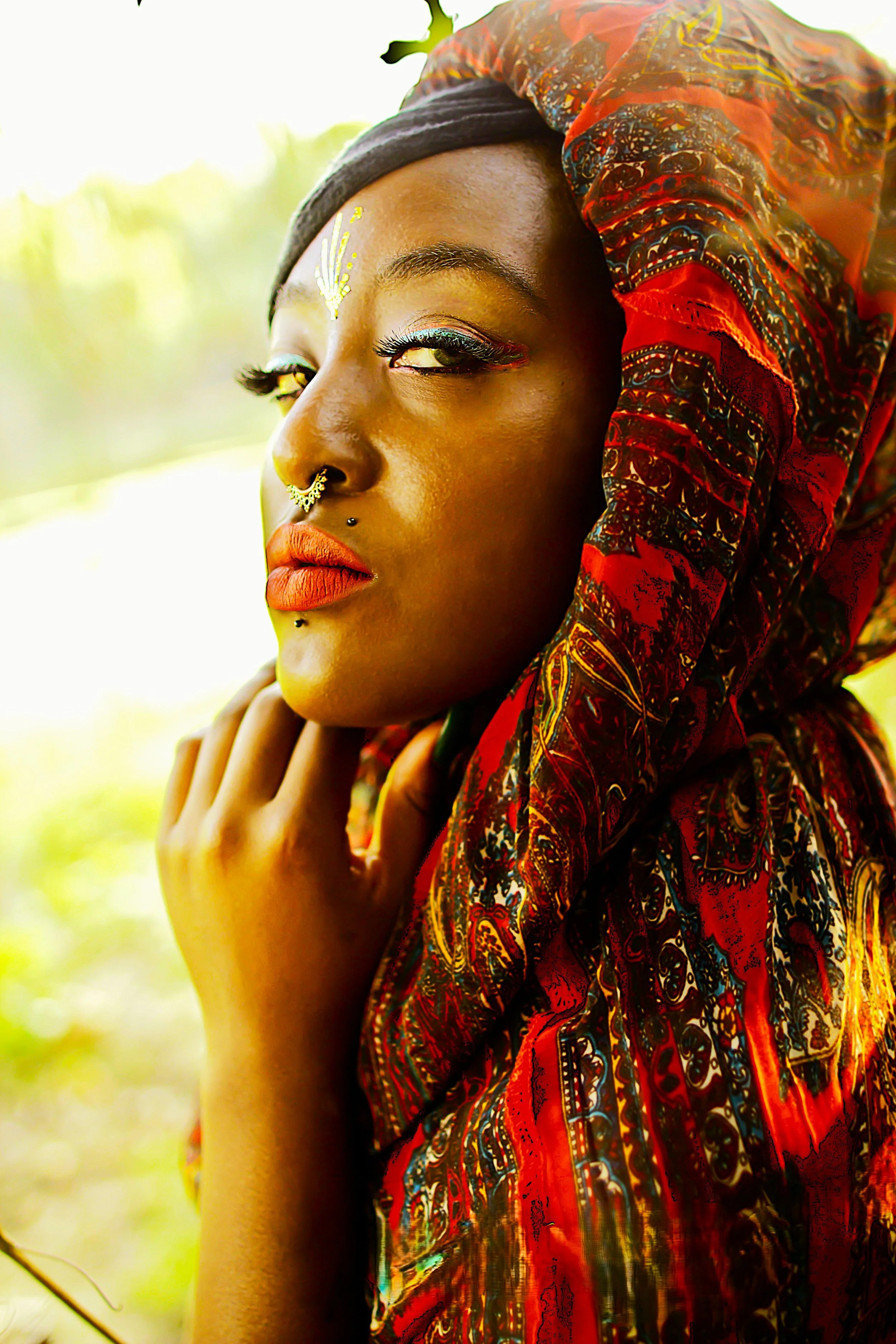 Bathed in warm golden light, the Queen of the Golden Sun turns toward the horizon in quiet reflection. The rich textures of her garments and the glow of the sunlight emphasize themes of strength, beauty, and inner power that define the spirit of the 