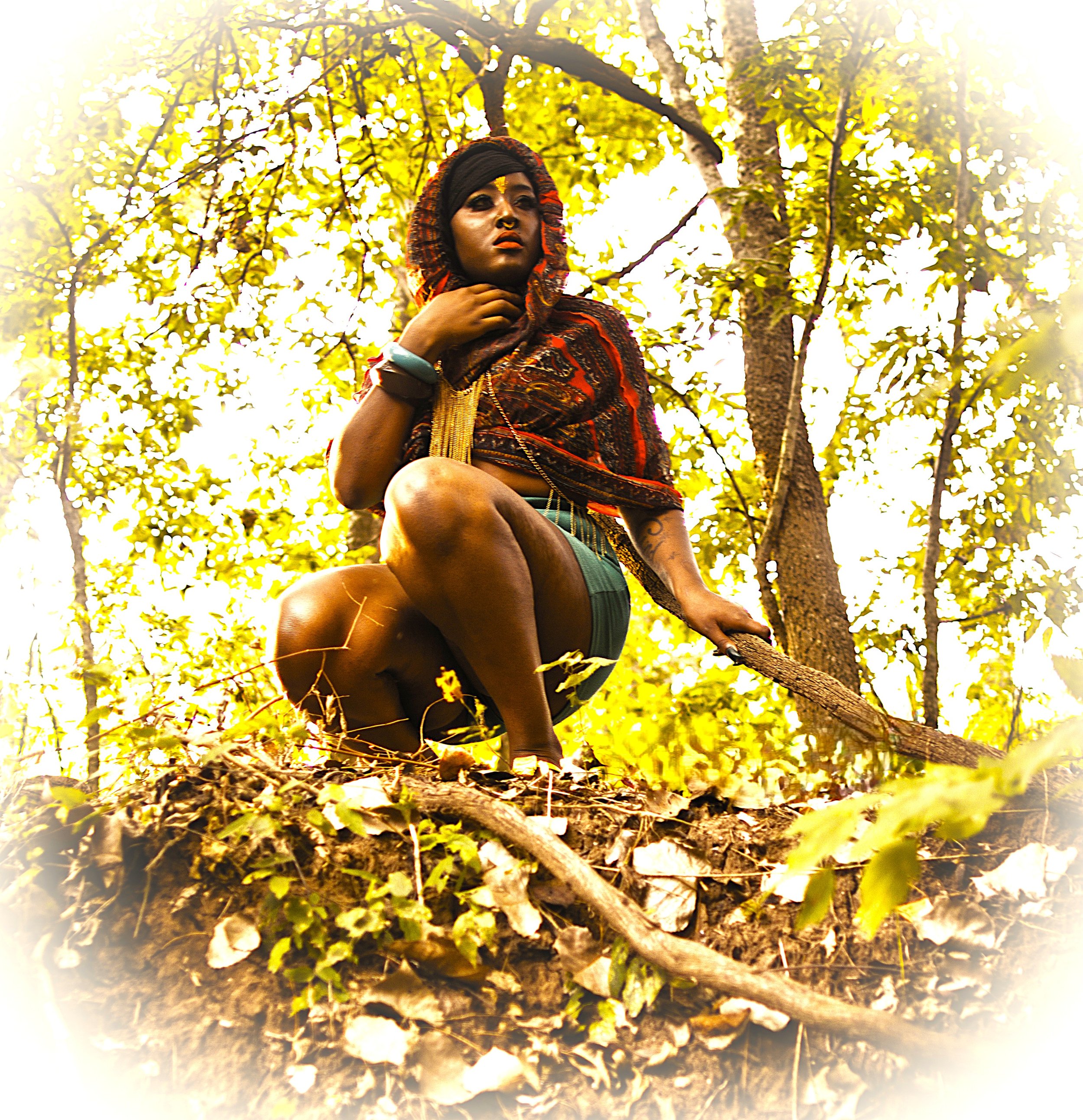 Perched above the forest floor and surrounded by glowing sunlight, the Queen of the Golden Sun surveys the world from her natural throne. The elevated perspective and radiant atmosphere emphasize themes of power, resilience, and connection to the ear