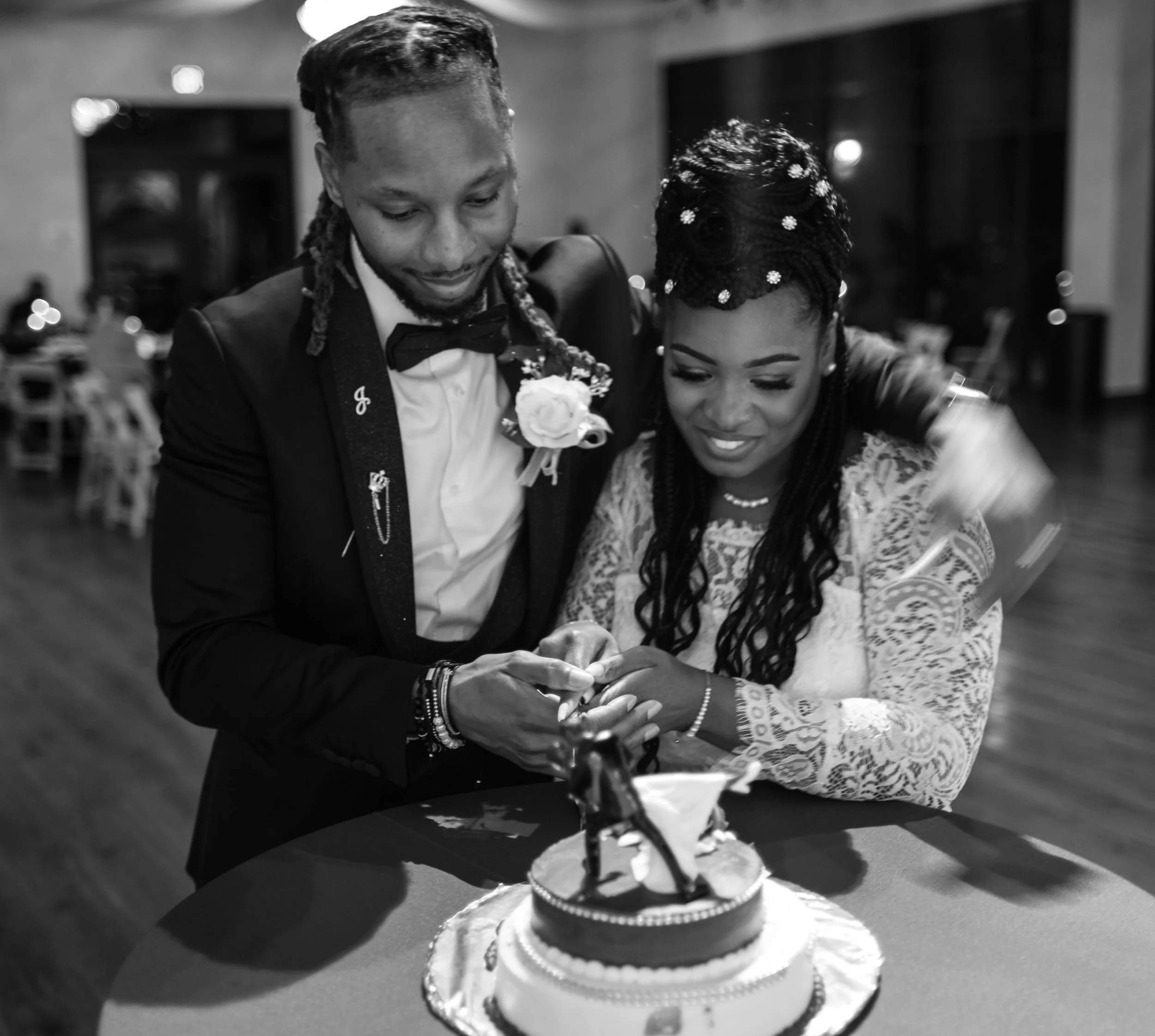 The bride and groom share a joyful moment while cutting their wedding cake during the reception. Captured by Caerus Multimedia, this image reflects the excitement and celebration that define unforgettable wedding receptions in Austin.