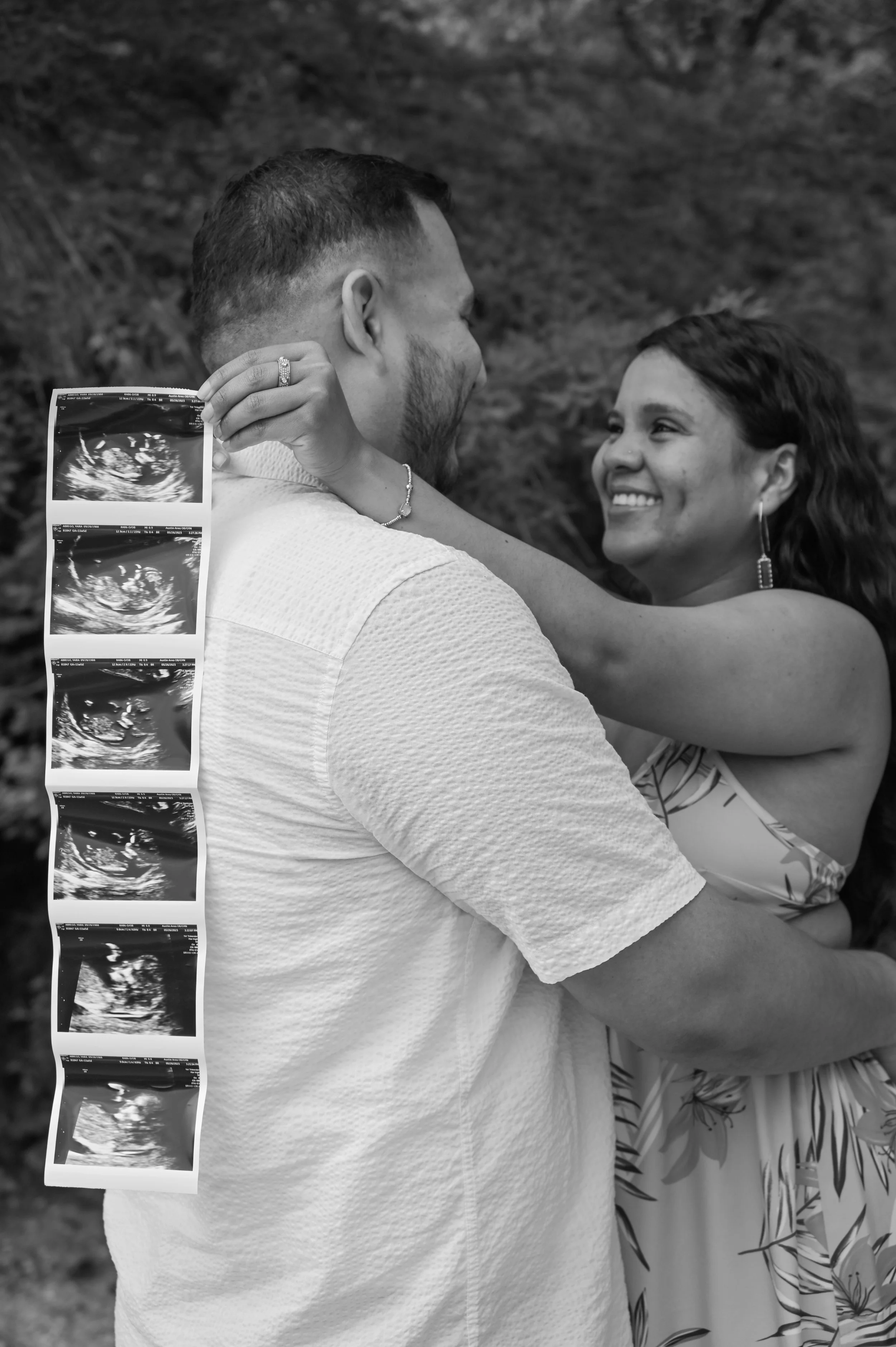 Couple embracing while revealing ultrasound photos during a heartfelt maternity photography session in Austin, Texas photographed by Caerus Multimedia.