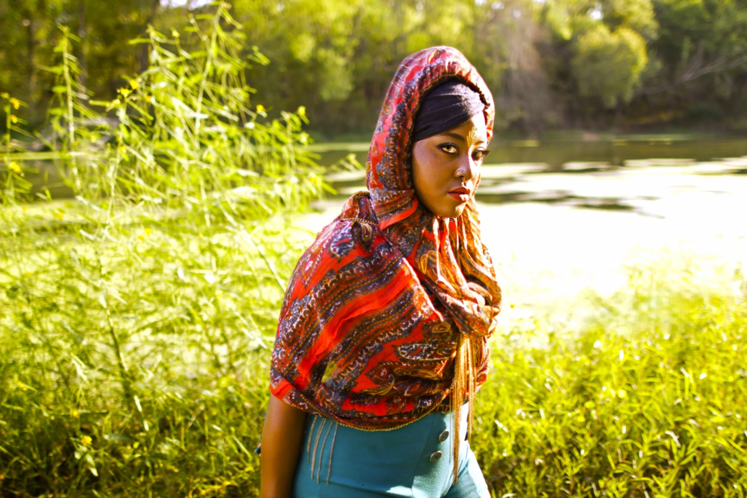 Bathed in warm golden light, the Queen looks beyond the horizon with quiet confidence. This portrait captures the spirit of the Queen of the Golden Sun—a visual story of strength, heritage, and the power found within stillness.