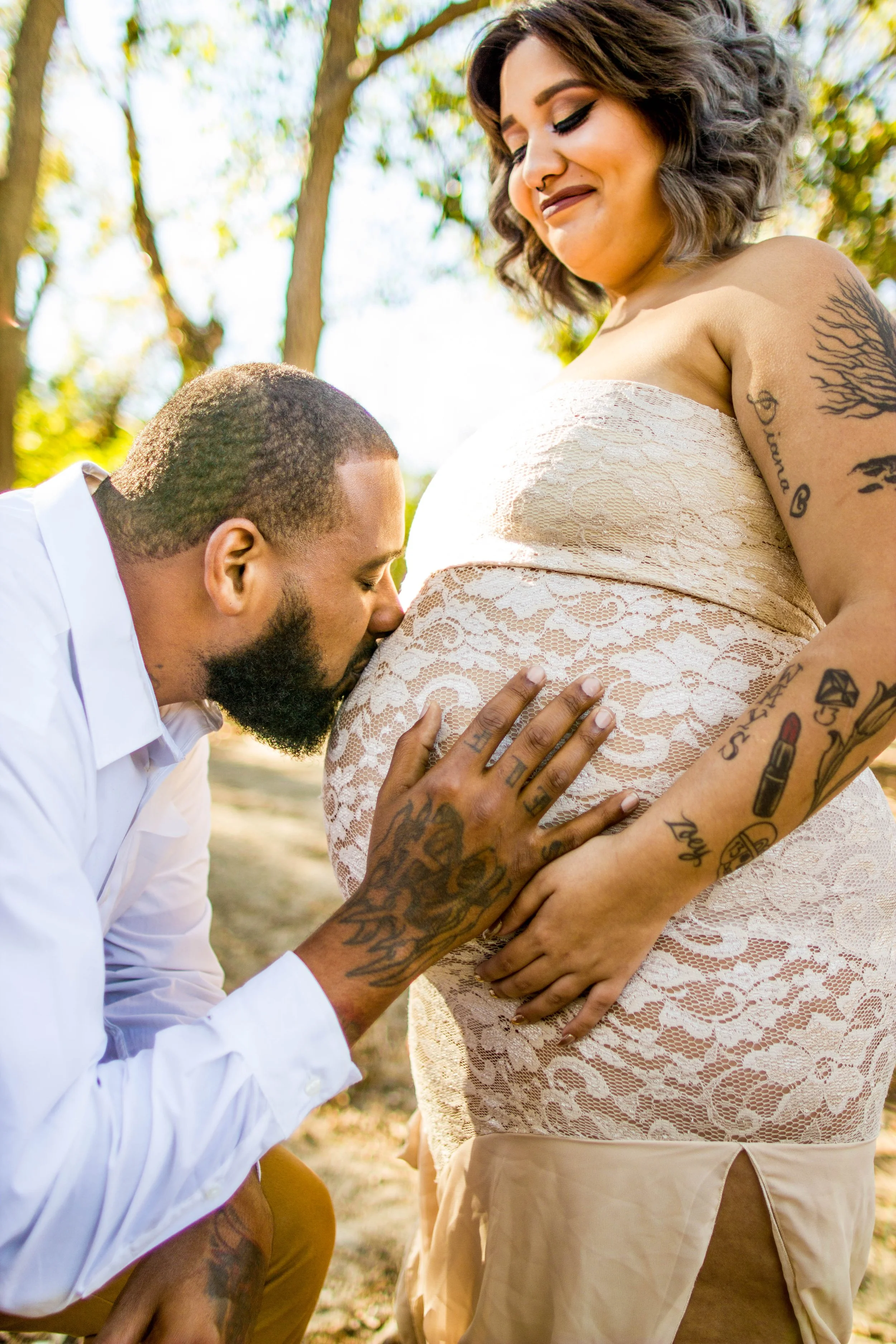 Expecting father kissing baby bump during an emotional maternity photography session in Austin, Texas captured by Caerus Multimedia.