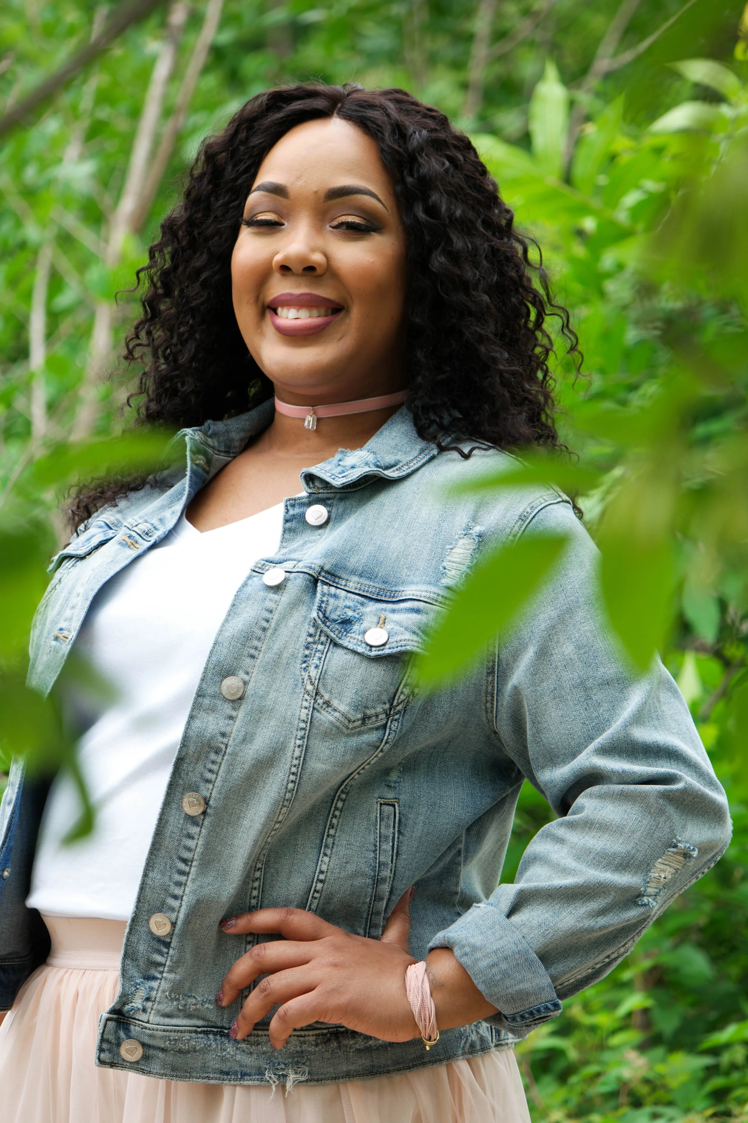 Framed by soft greenery and natural light, this portrait was captured during an outdoor session in Austin, Texas. The surrounding foliage creates a calm, natural backdrop that helps draw attention to the subject’s expression and confidence. Caerus Mu