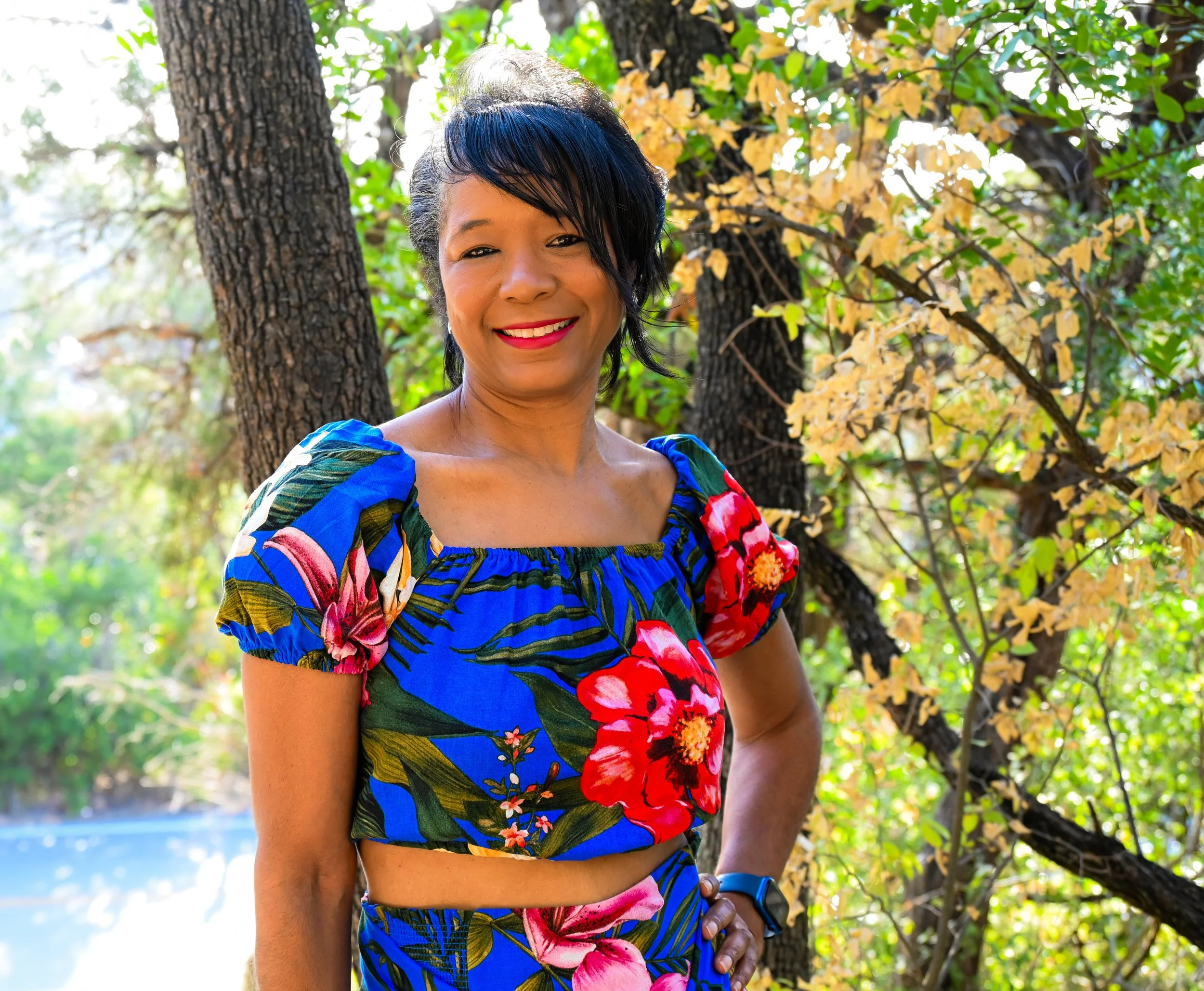 A peaceful outdoor portrait taken in a quiet forest setting in Austin, Texas. Natural light filtering through the trees creates a soft atmosphere, allowing the subject’s personality and expression to take center stage.