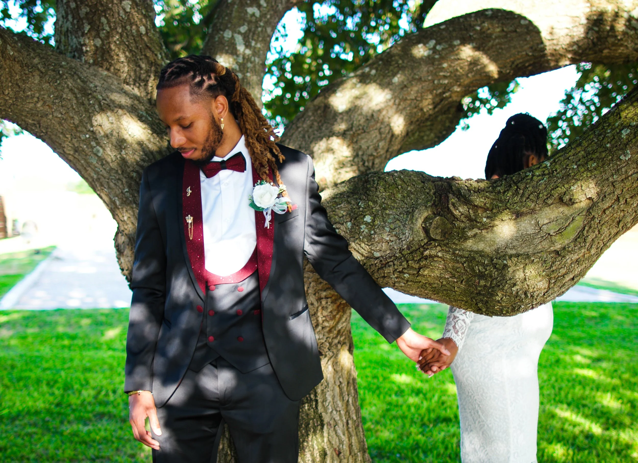 A quiet first-look moment beneath a sprawling oak tree as the bride and groom reach for each other before their ceremony. Captured by Austin wedding photographer Caerus Multimedia, this image reflects the emotional storytelling and natural moments th