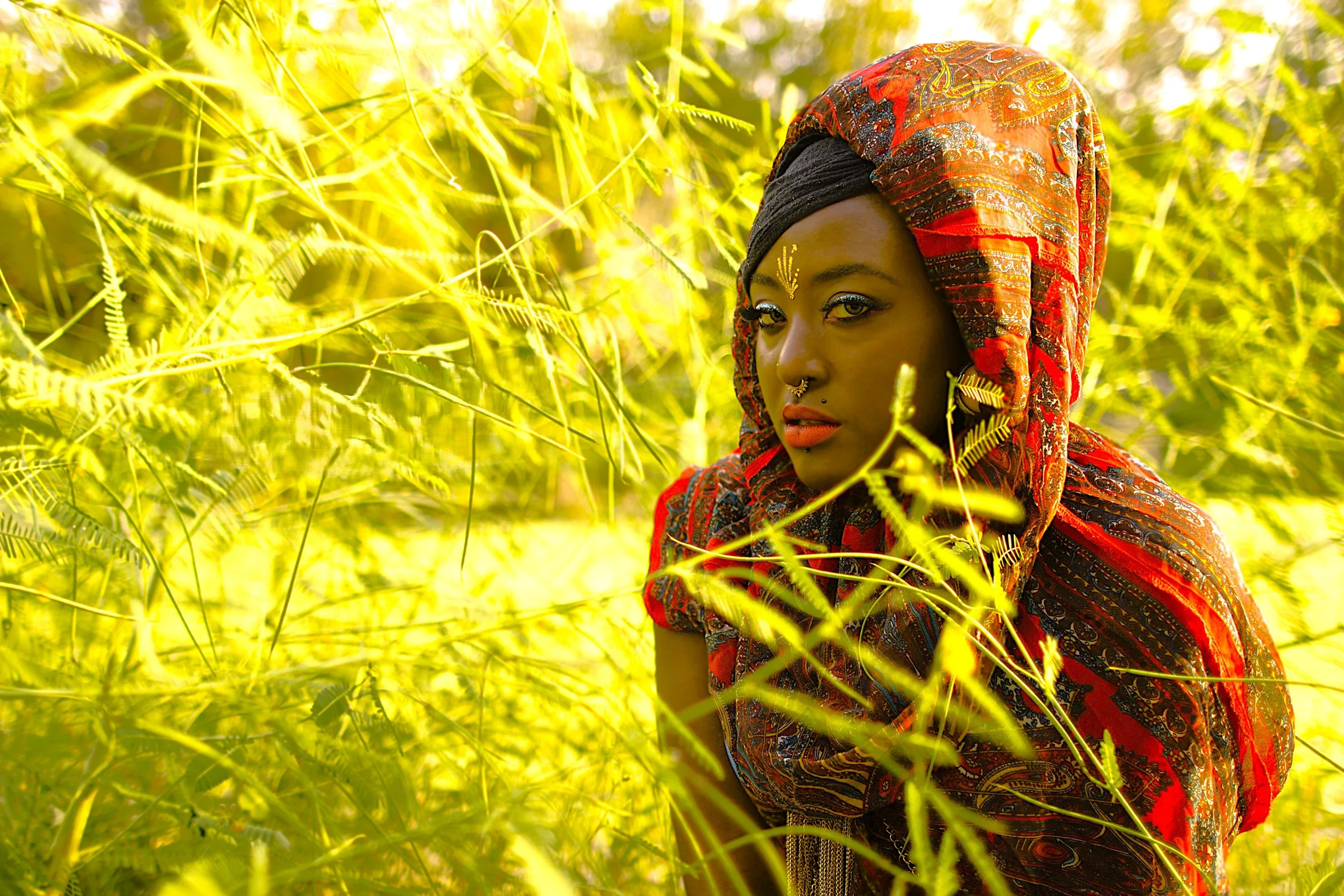 Partially hidden within the glowing greenery, the Queen observes the world with a calm but commanding presence. The interplay of light, color, and nature reflects themes of strength, awareness, and inner power.