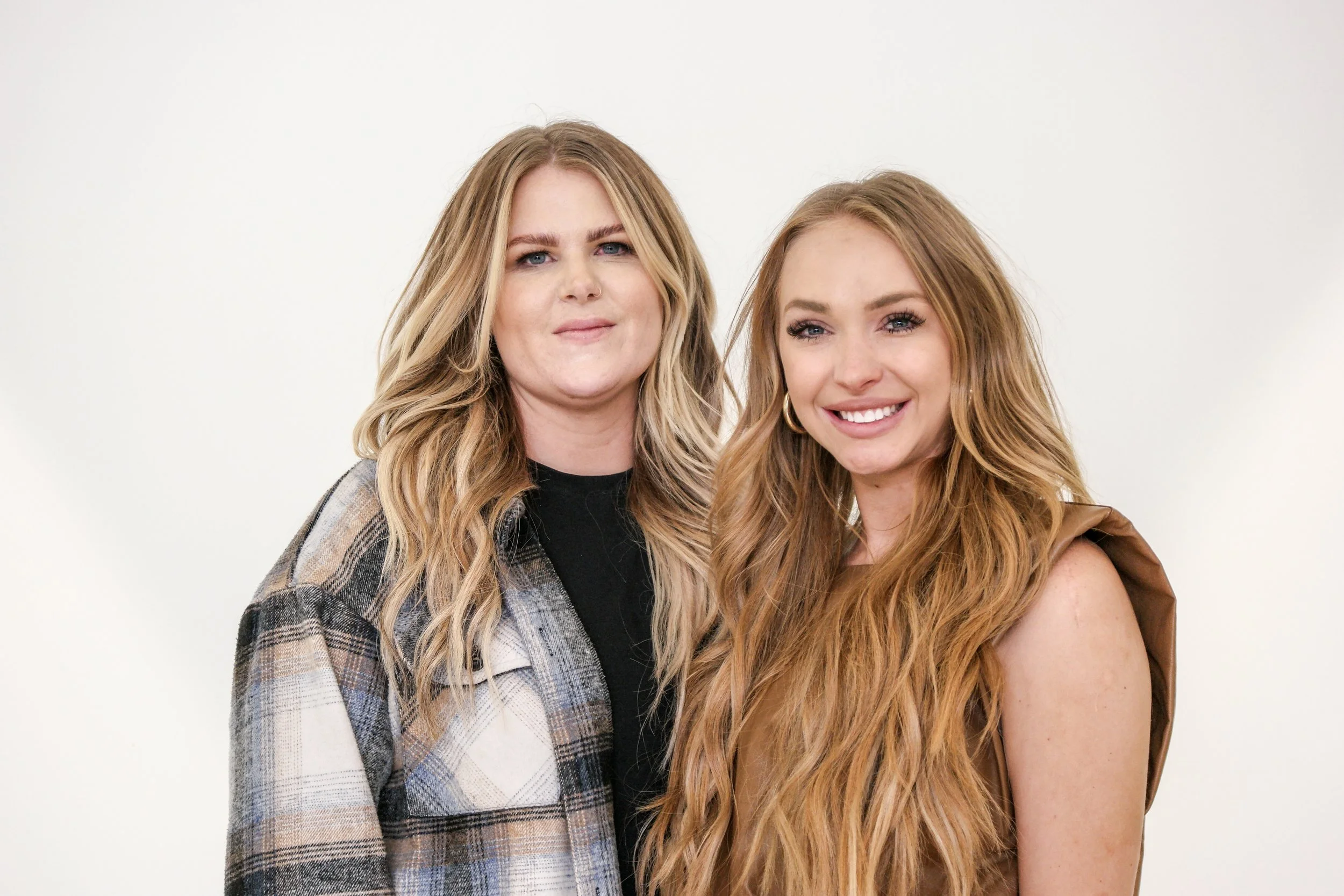 A clean studio-style portrait captured during a lifestyle session in Austin, Texas. Simple lighting and a neutral backdrop allow the personalities of the subjects to stand out, creating a relaxed and natural portrait that feels genuine rather than ov