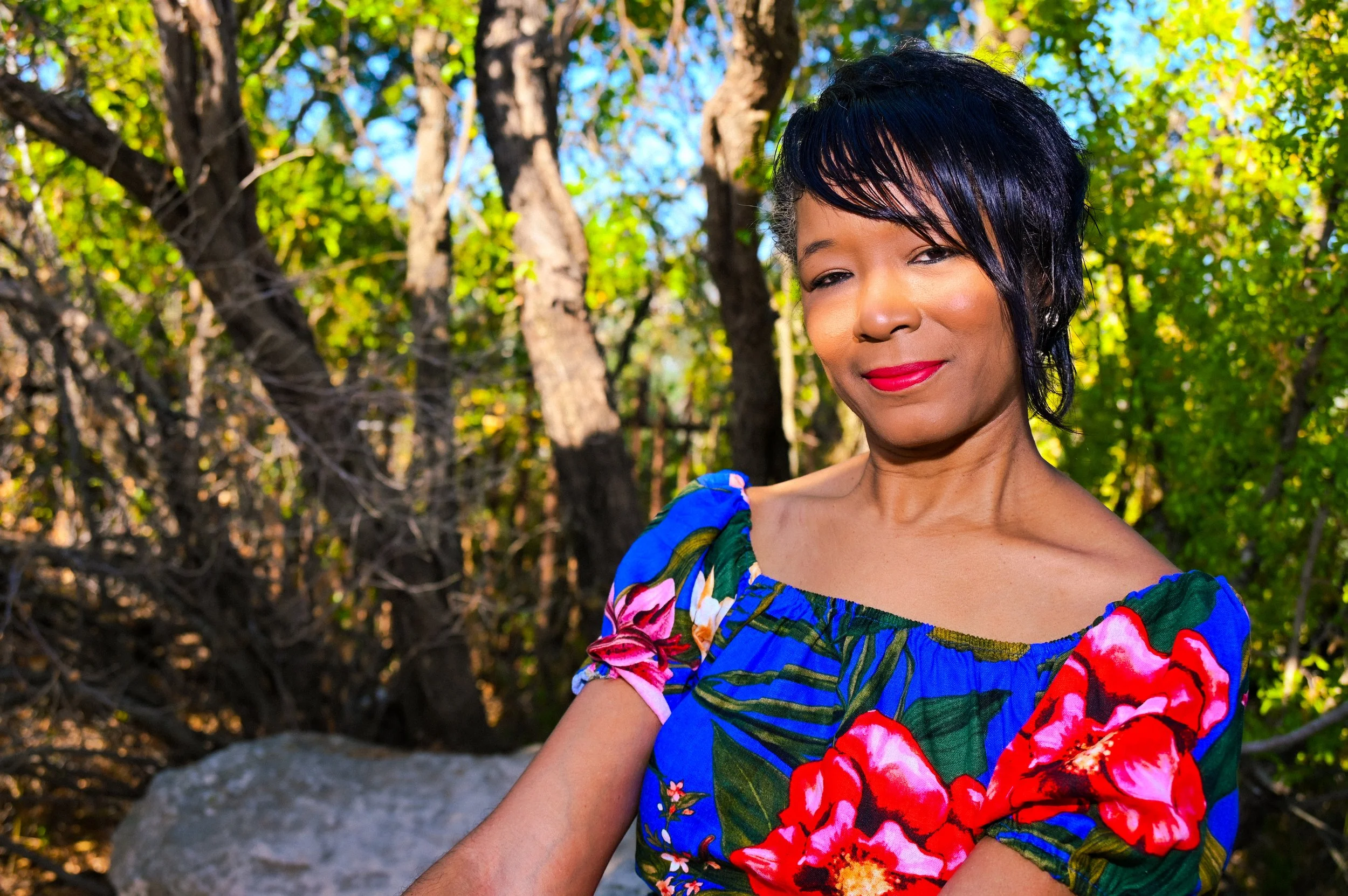 Golden Texas sunlight filters through the trees during this outdoor portrait session in Austin. The natural setting and vibrant colors give the image a warm, energetic feel while still keeping the focus on expression and presence. Caerus Multimedia p