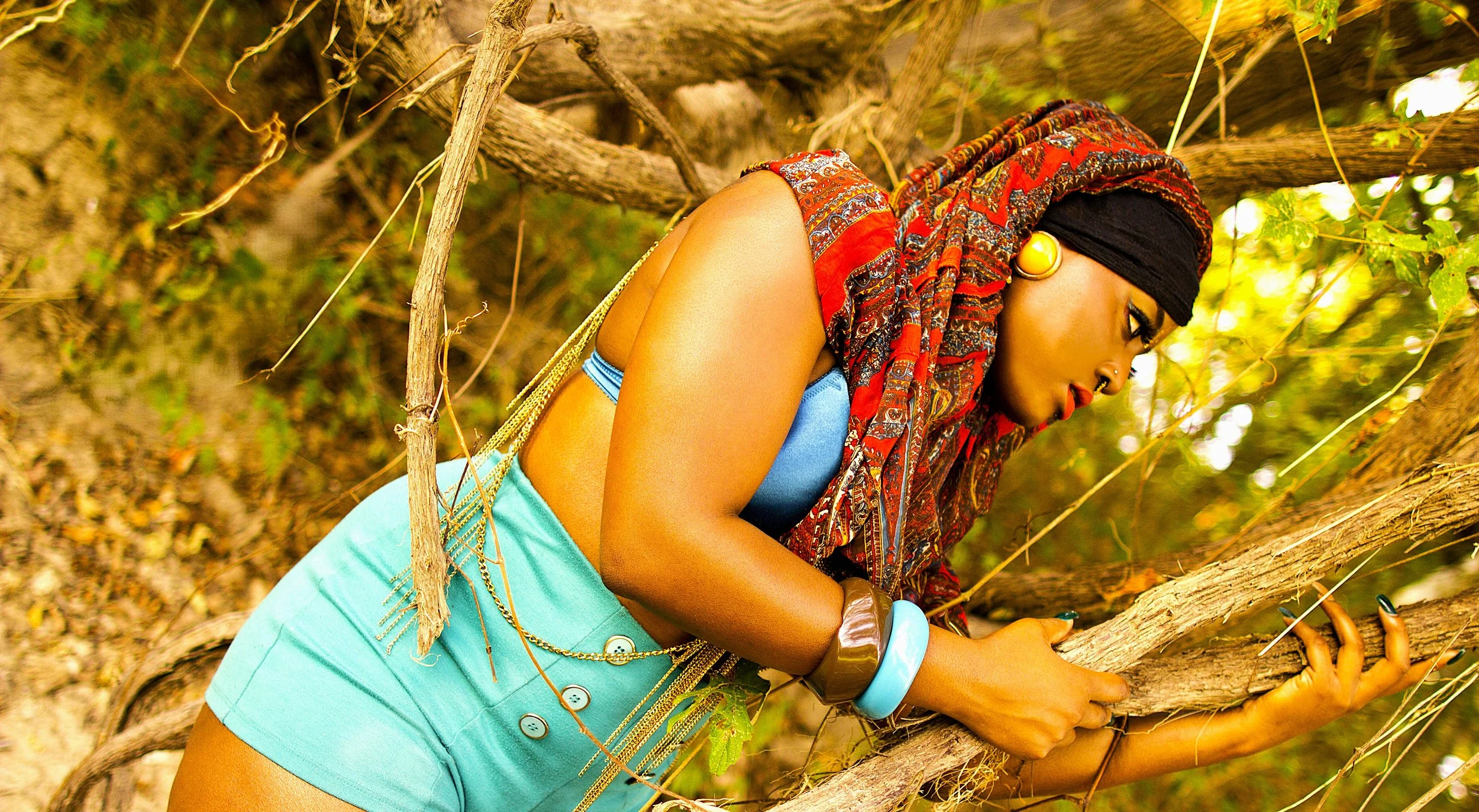 Leaning into the twisted branches of the forest, the Queen appears both grounded and unshaken. The surrounding earth and sunlight frame her as a symbol of endurance, balance, and connection to the natural world.