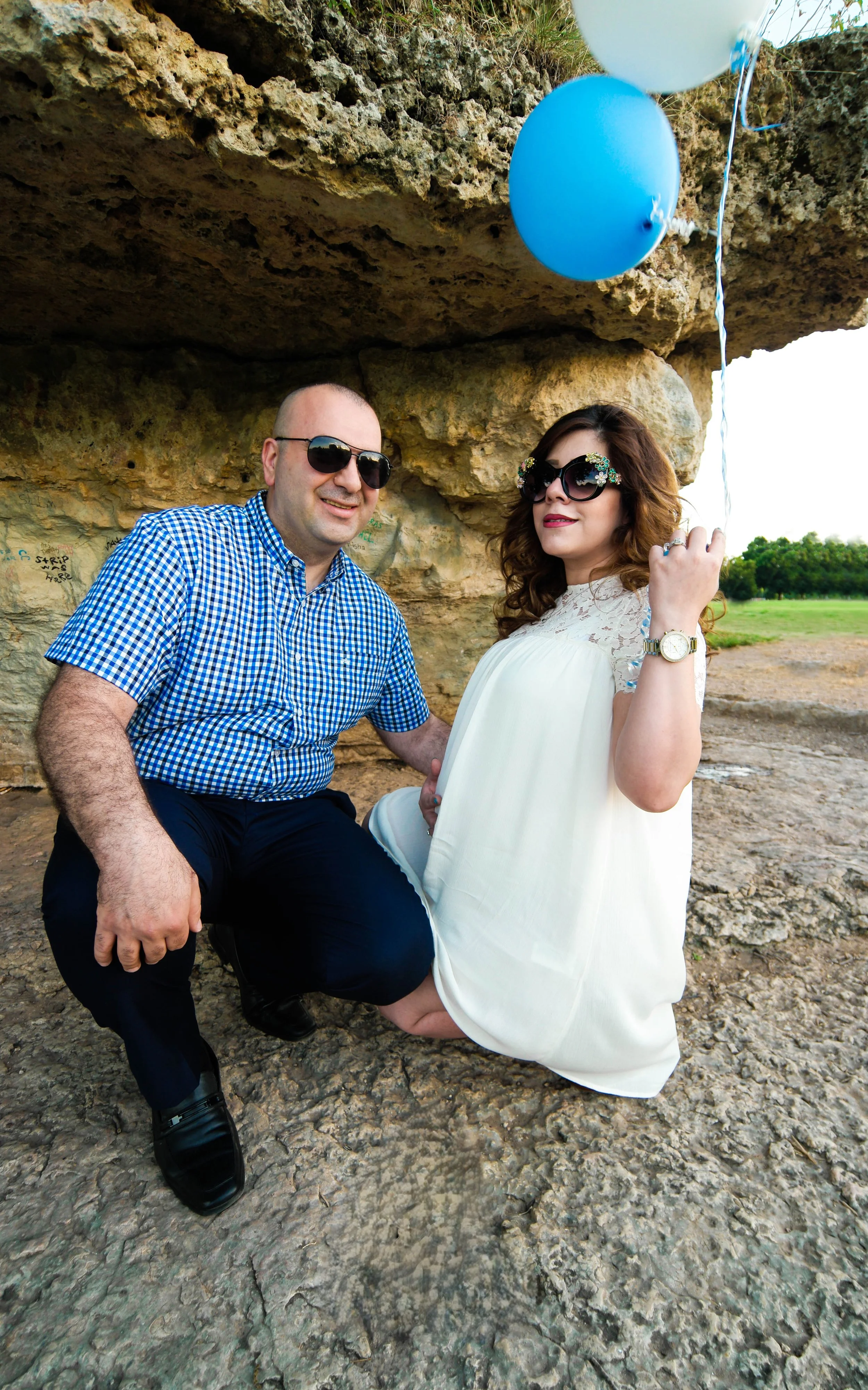 Stylish maternity portrait of expecting parents holding baby announcement balloons during an outdoor maternity photography session in Austin, Texas photographed by Caerus Multimedia, an Austin maternity photographer specializing in natural pregnancy 