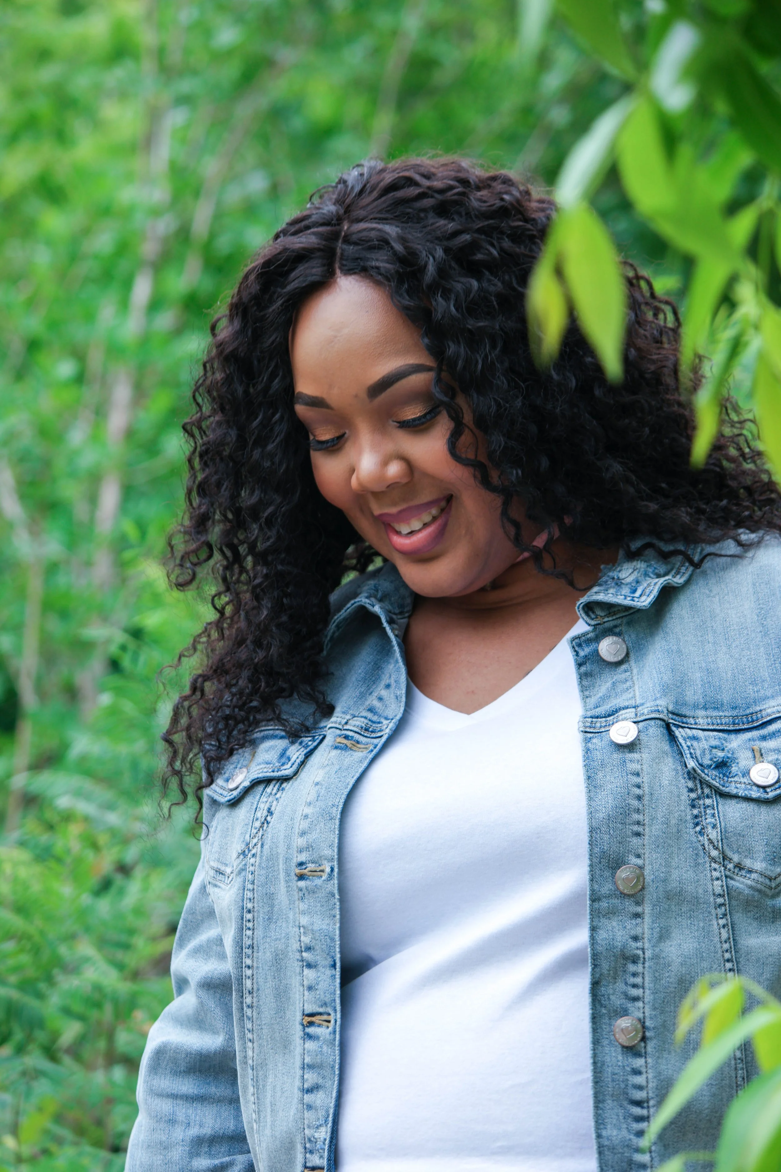 A relaxed natural-light portrait photographed along the river in Austin, Texas. The soft greens of the surrounding landscape frame the subject beautifully, creating a lifestyle portrait that feels authentic, warm, and effortless — a style Caerus Mult