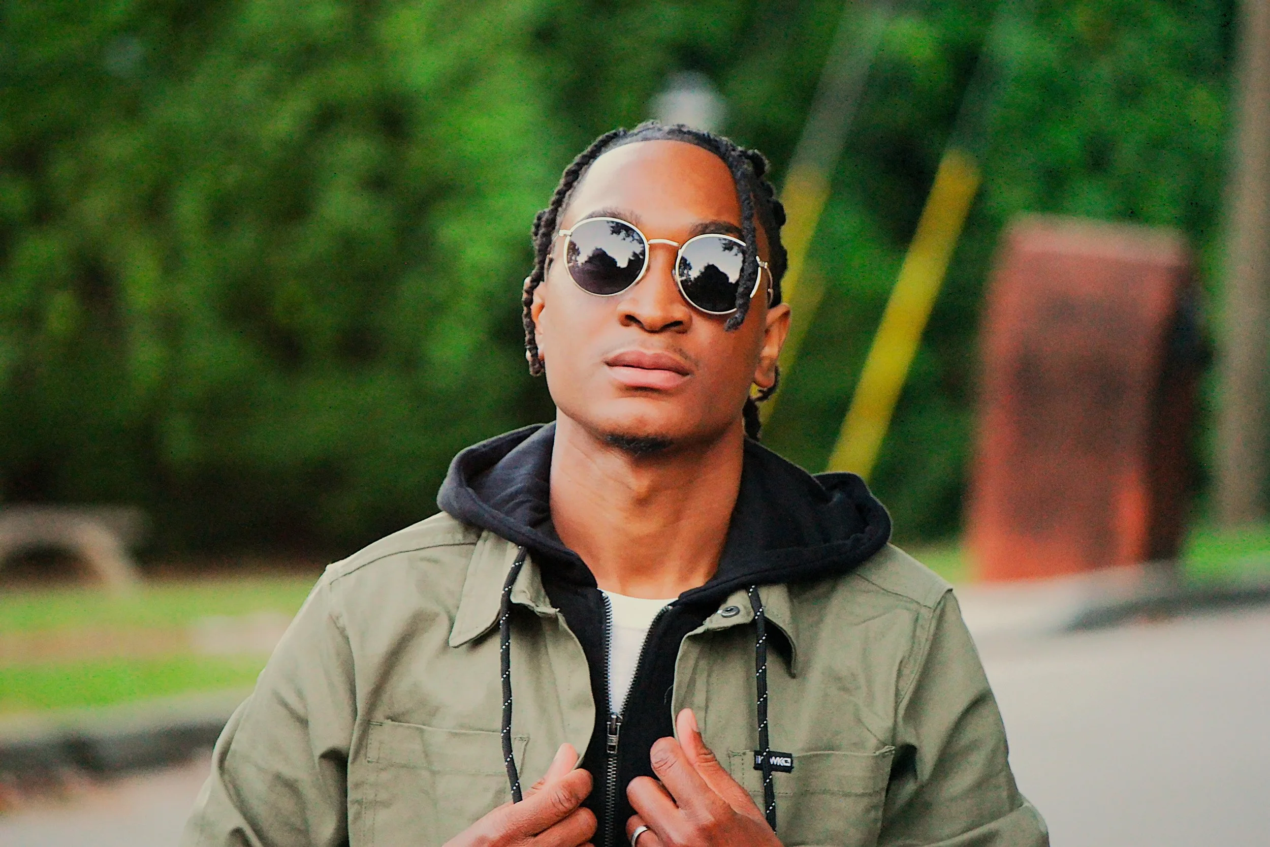 A natural light portrait captured outdoors in Atlanta, Georgia. The subject’s confident expression and modern styling create a clean, contemporary portrait that blends fashion and personality with a relaxed environment.