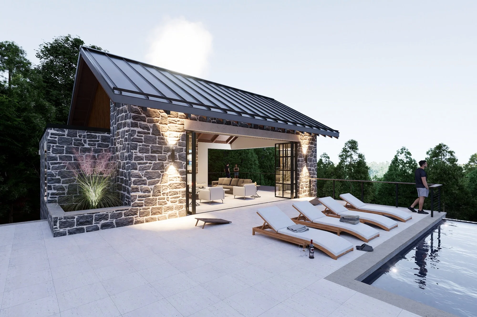 Luxury outdoor patio with a stone pool house, a swimming pool, and four lounge chairs with towels. Two people are inside the building, and a man is standing at the railing outside, possibly reading or looking at the view.