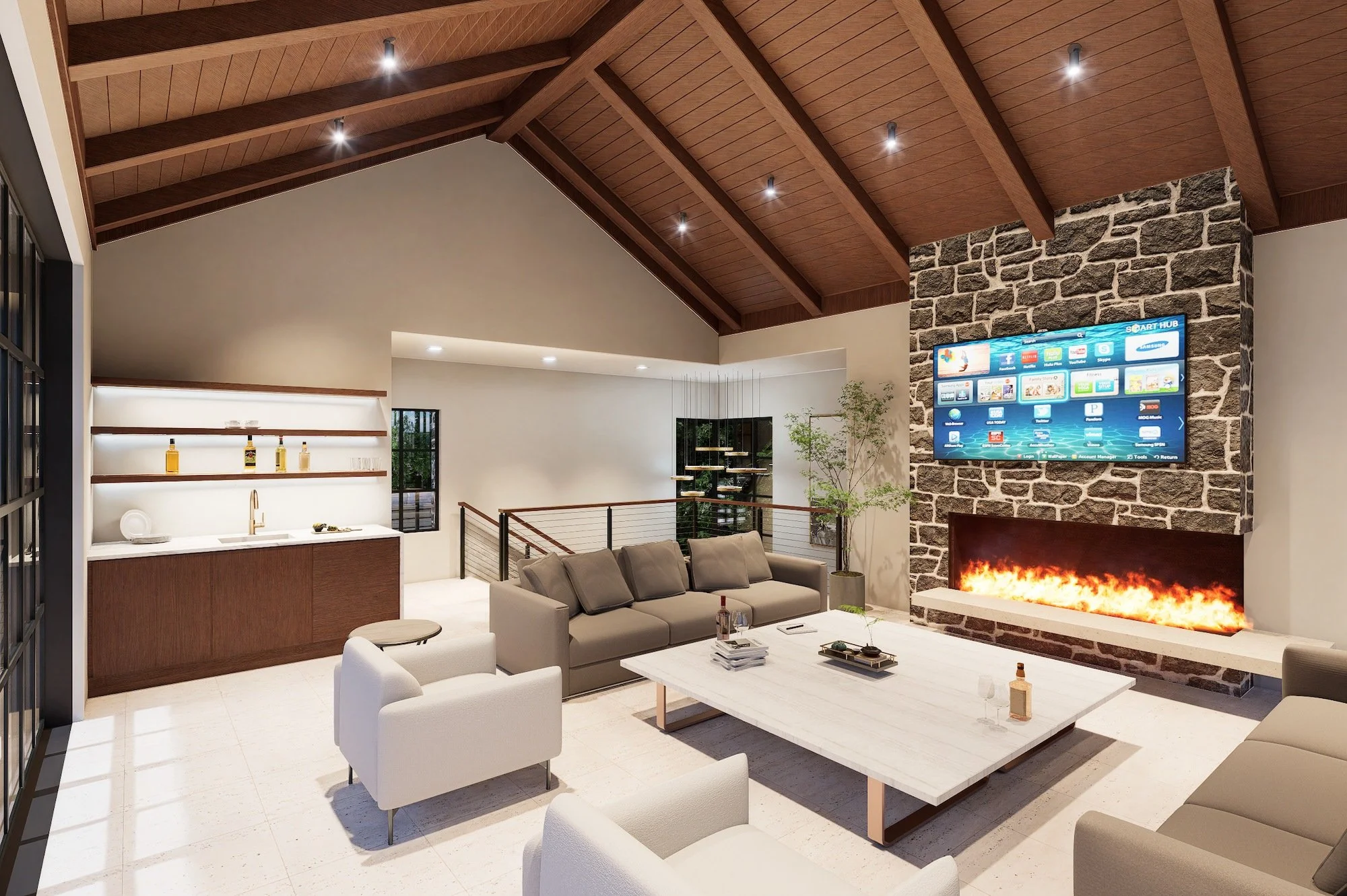 Living room with high wooden ceiling, stone fireplace with TV above, sofa, armchairs, a white coffee table with drinks and books, and a small bar area with bottles and glasses.