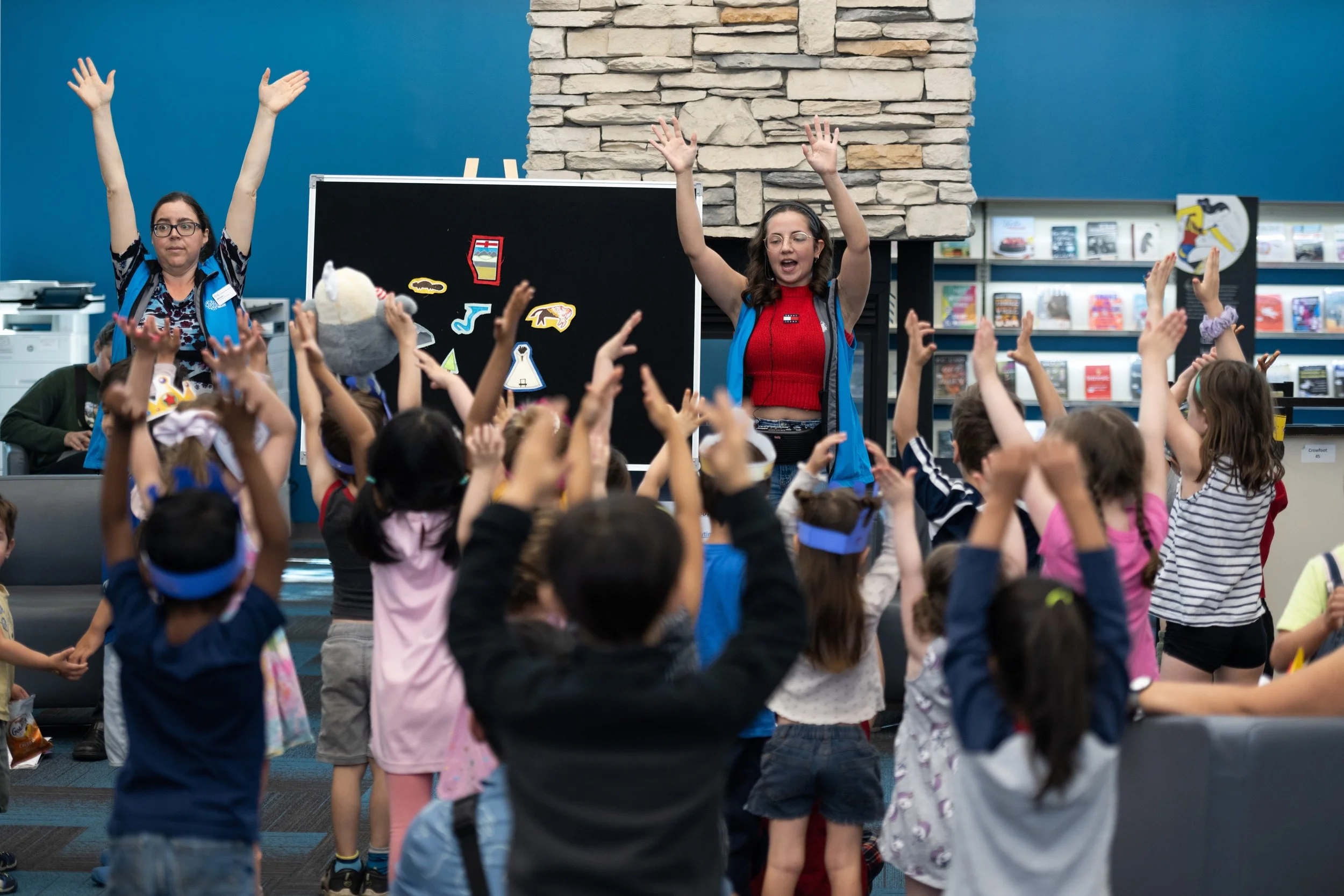 Children and staff taking part in a library activity
