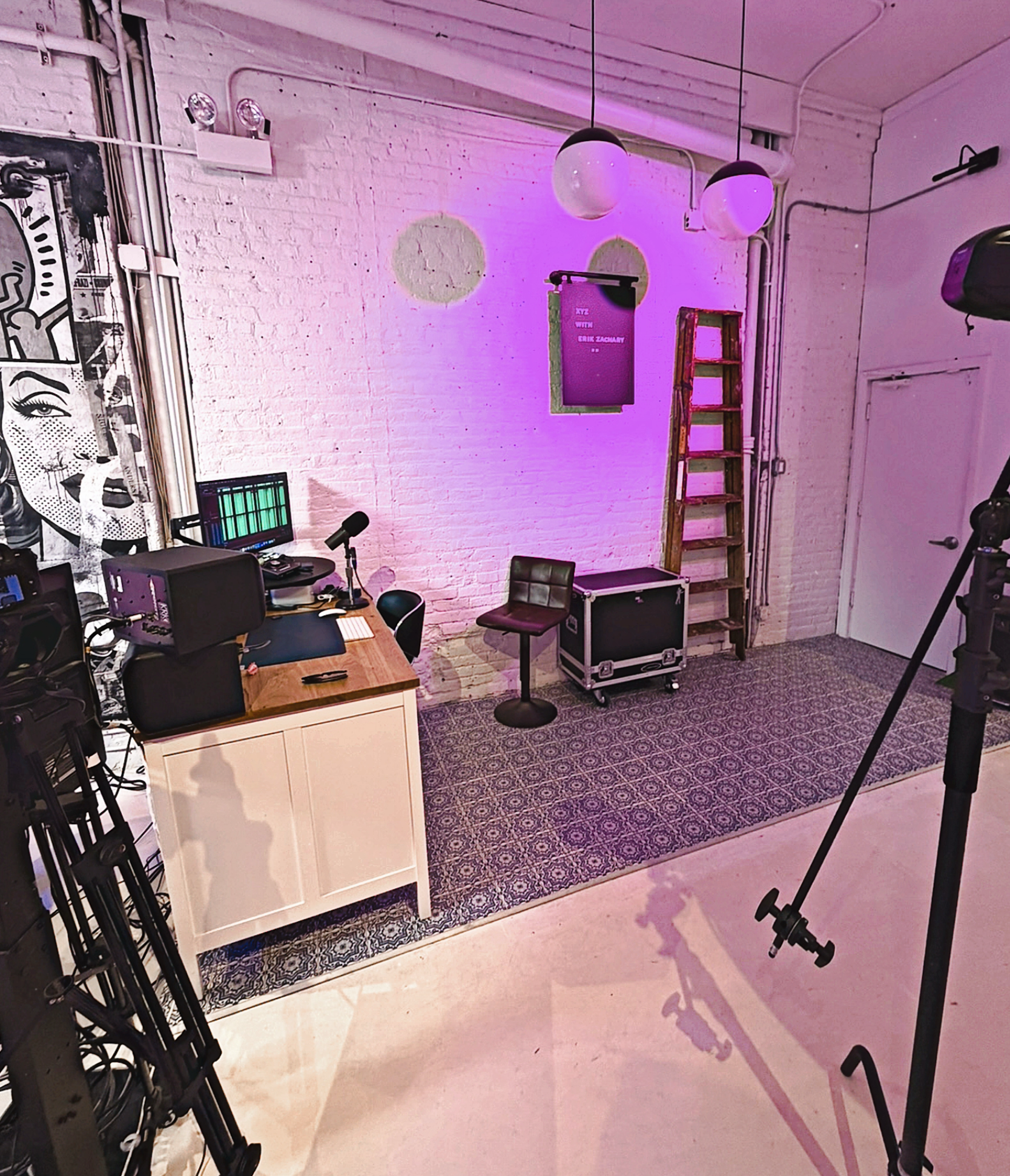 Podcast and video recording studio at XYZ Studios Chicago with microphone desk setup, lighting equipment, and white brick backdrop in River North.