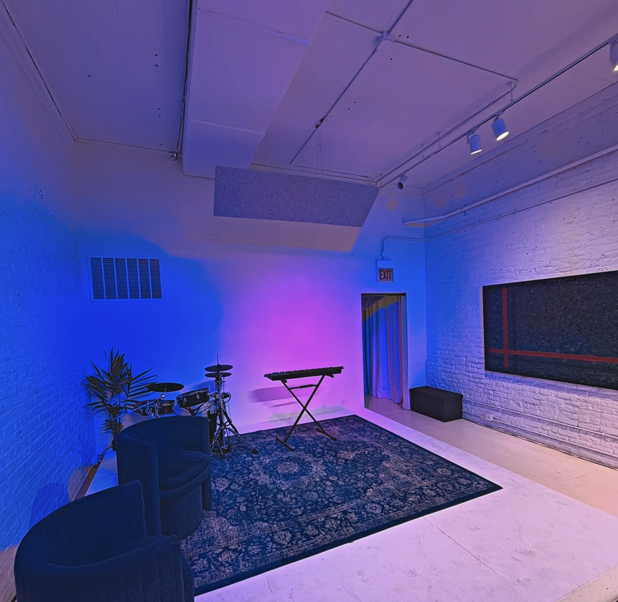 Performance and music recording area at XYZ Studios Chicago with drum kit, keyboard, and stage lighting inside the River North creative studio space.