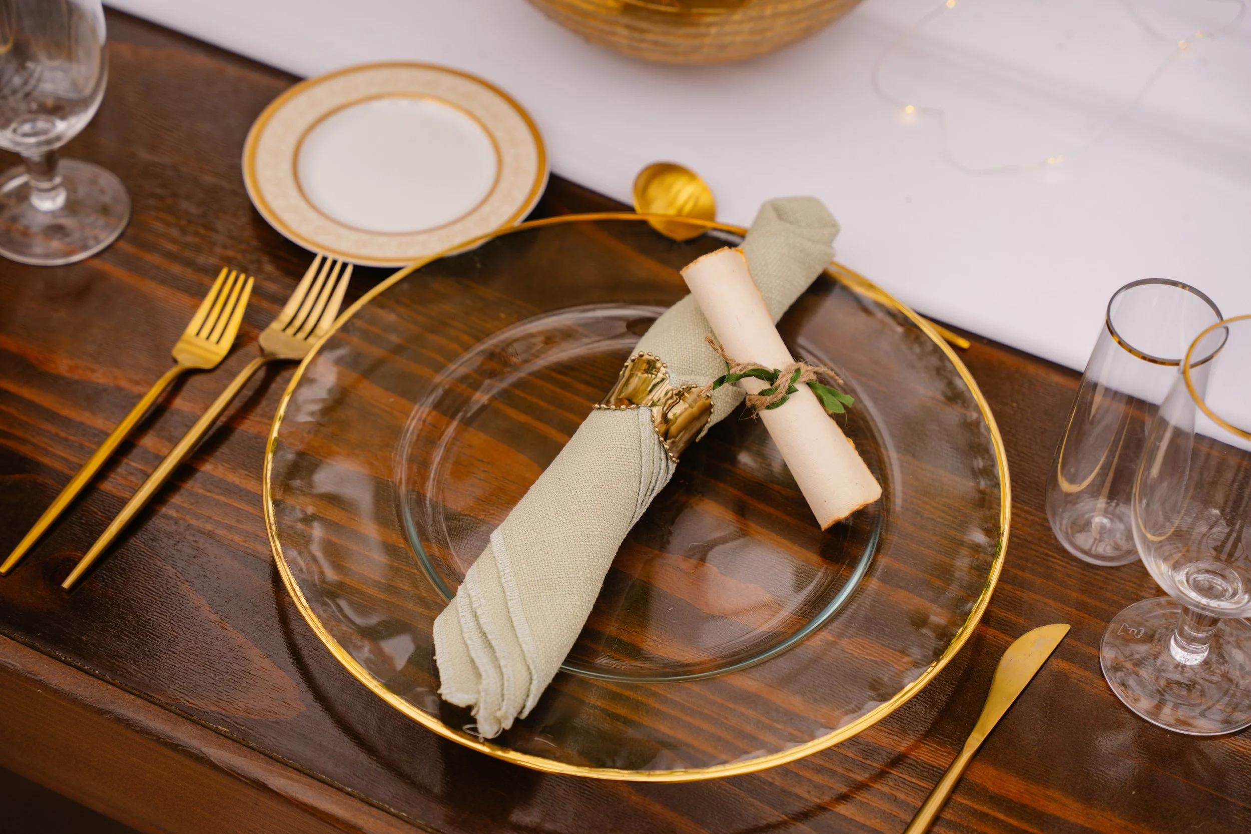 Wedding table setting with plates, menu, and decor details styled for South Florida wedding reception