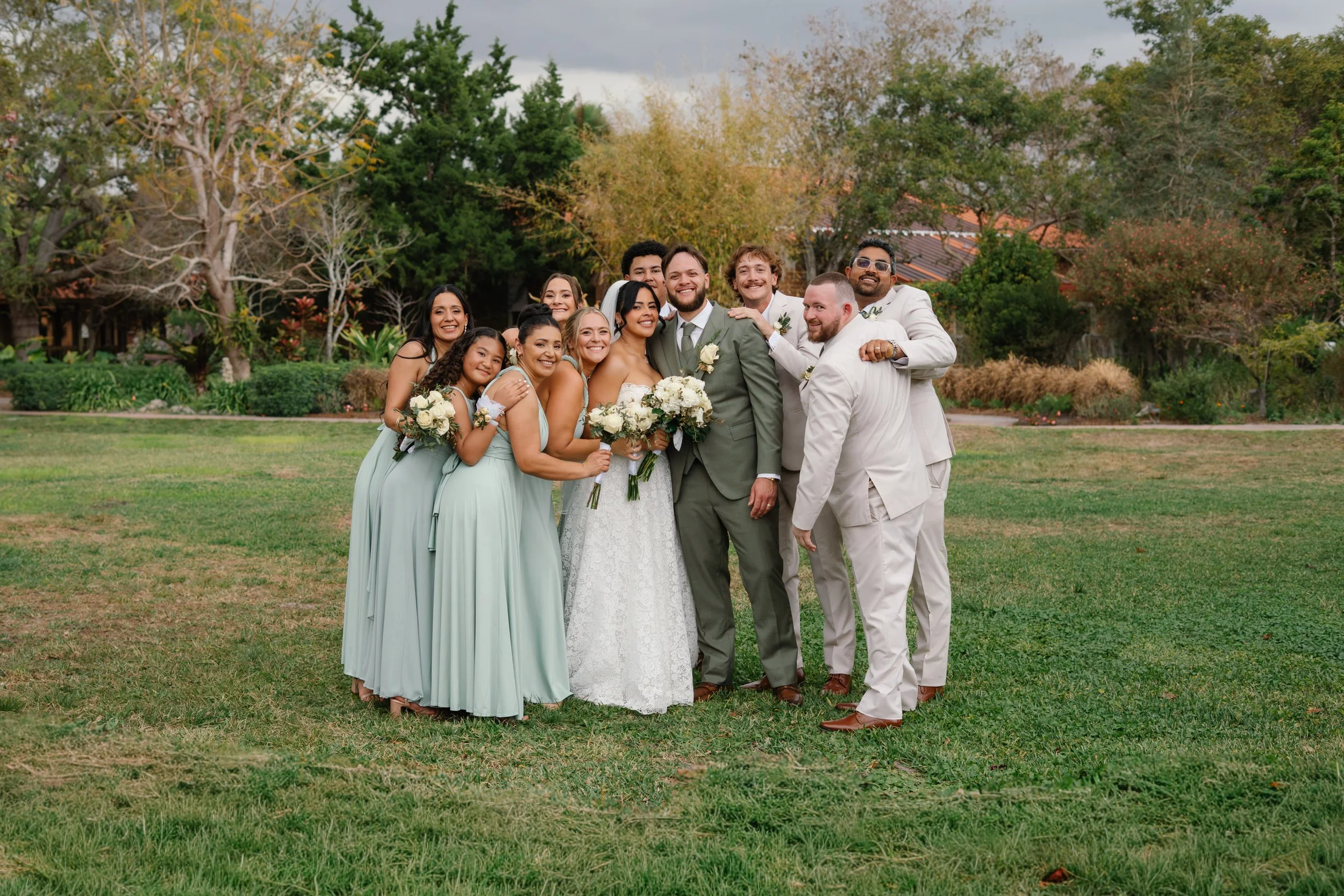Wedding party group portrait with bride and groom surrounded by friends in South Florida