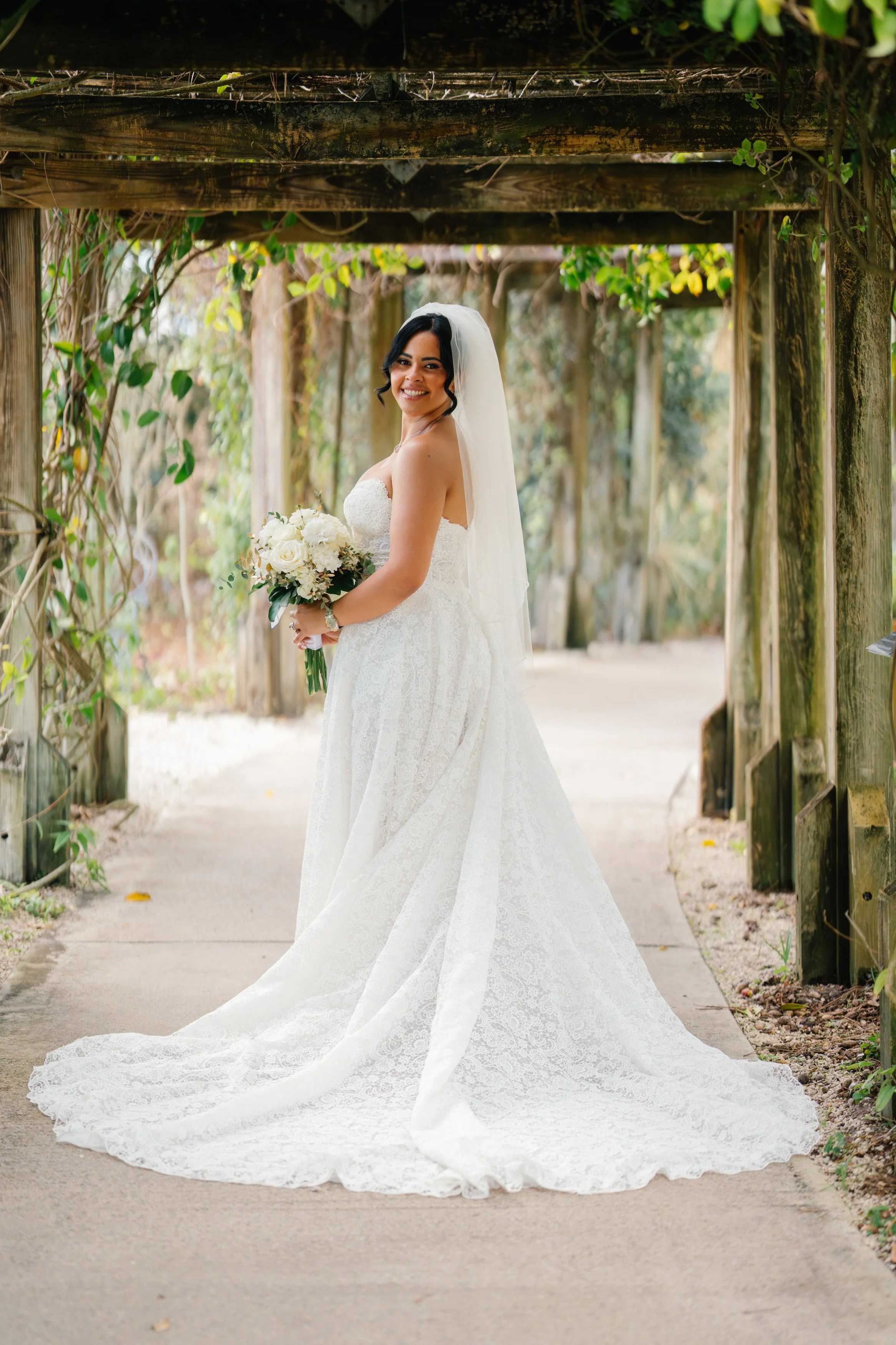 Bride portrait holding bouquet with soft natural light in South Florida wedding setting