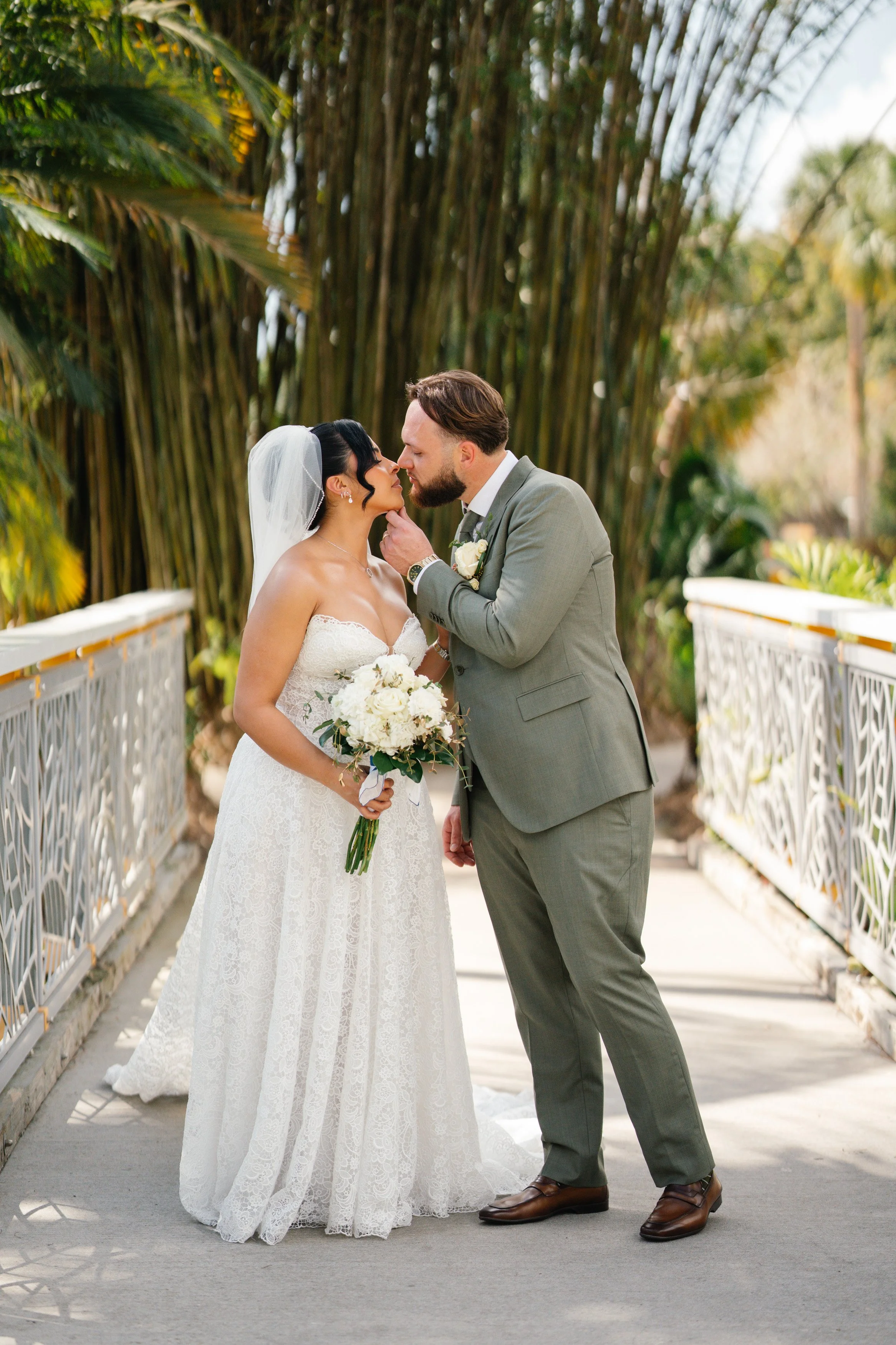 Groom kissing bride during romantic wedding portrait session in South Florida