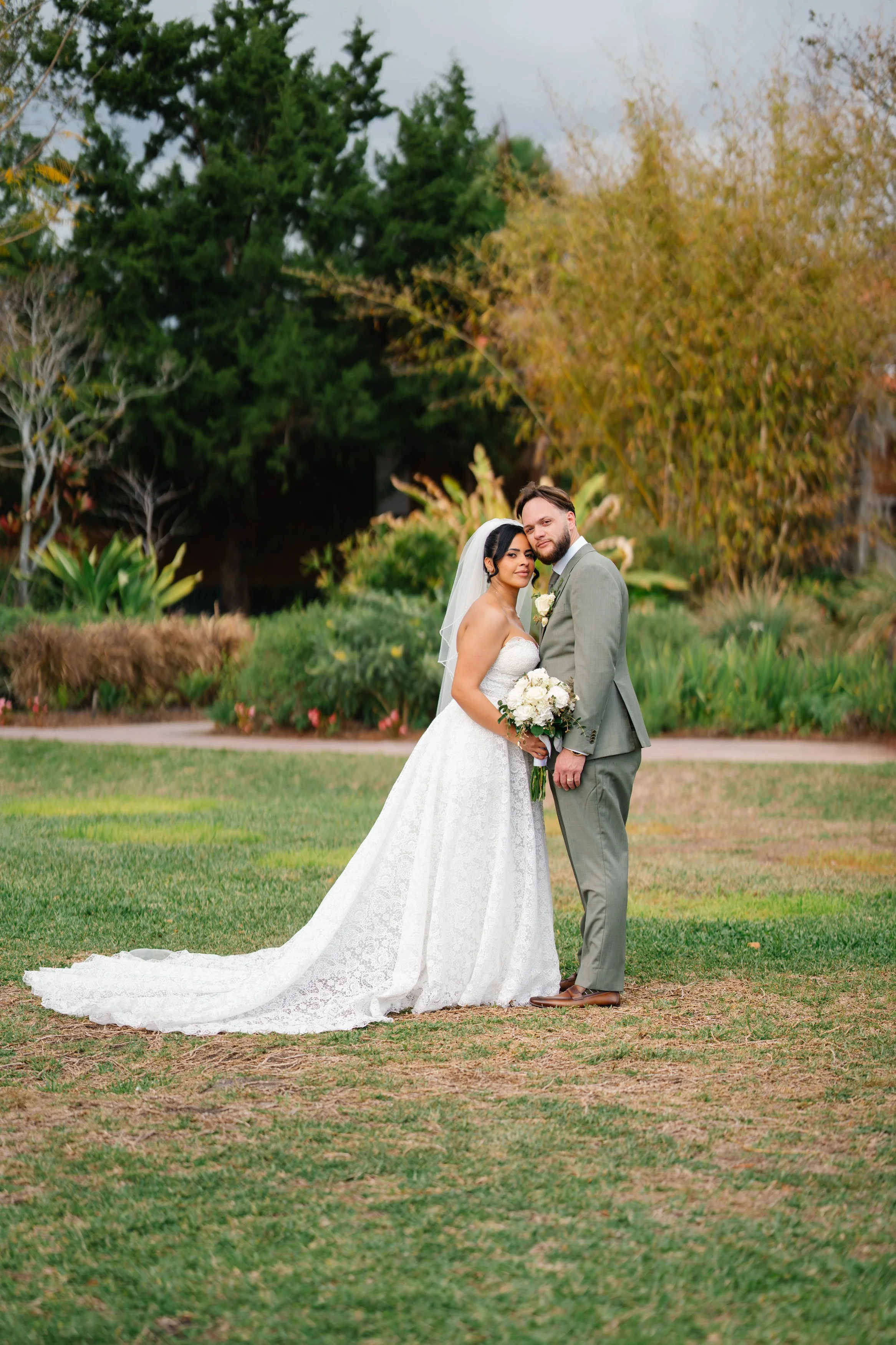 Bride and groom full length portrait in outdoor garden setting during South Florida wedding day