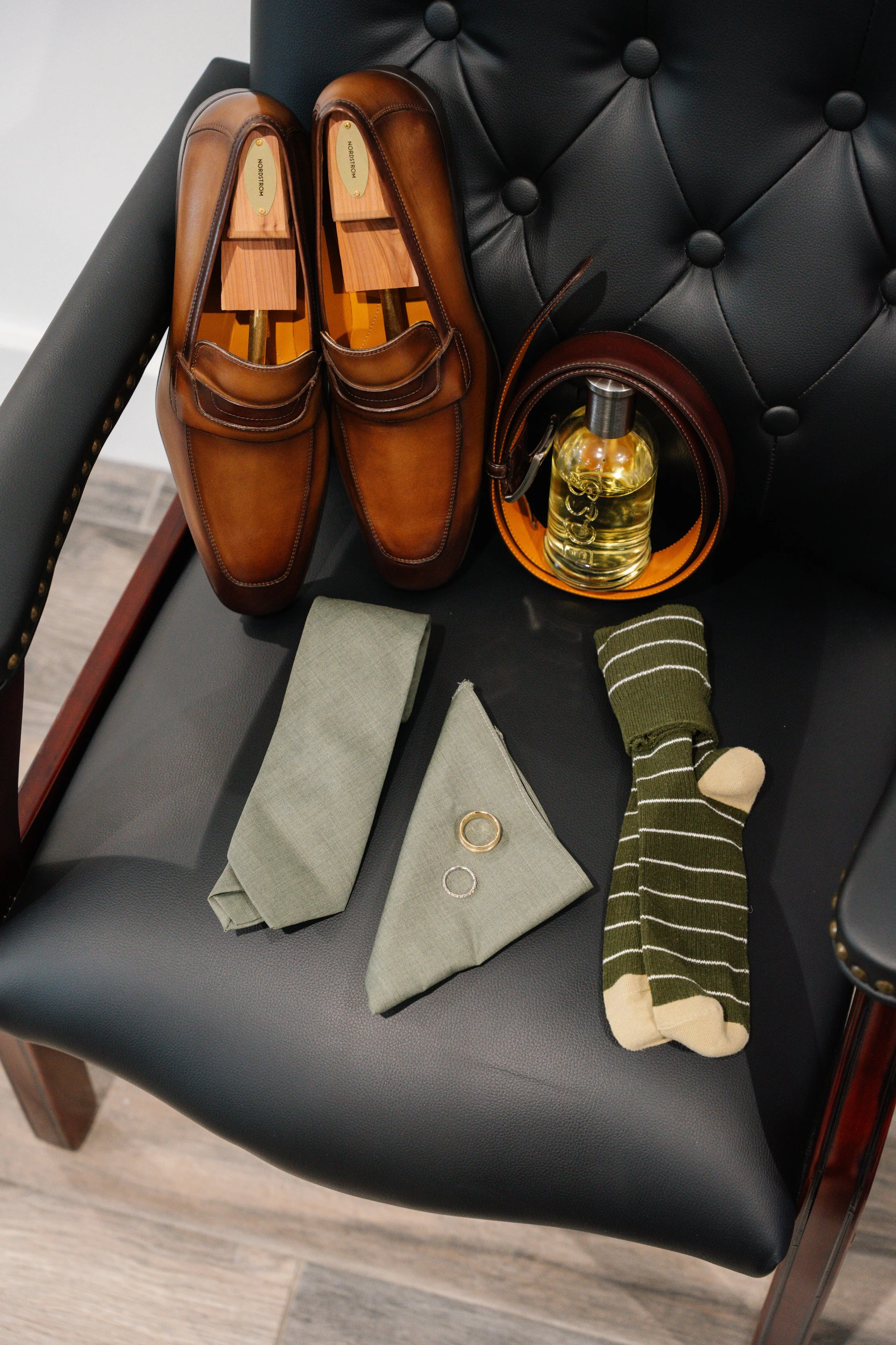 Groom details with dress shoes, socks, and accessories styled before wedding ceremony in South Florida