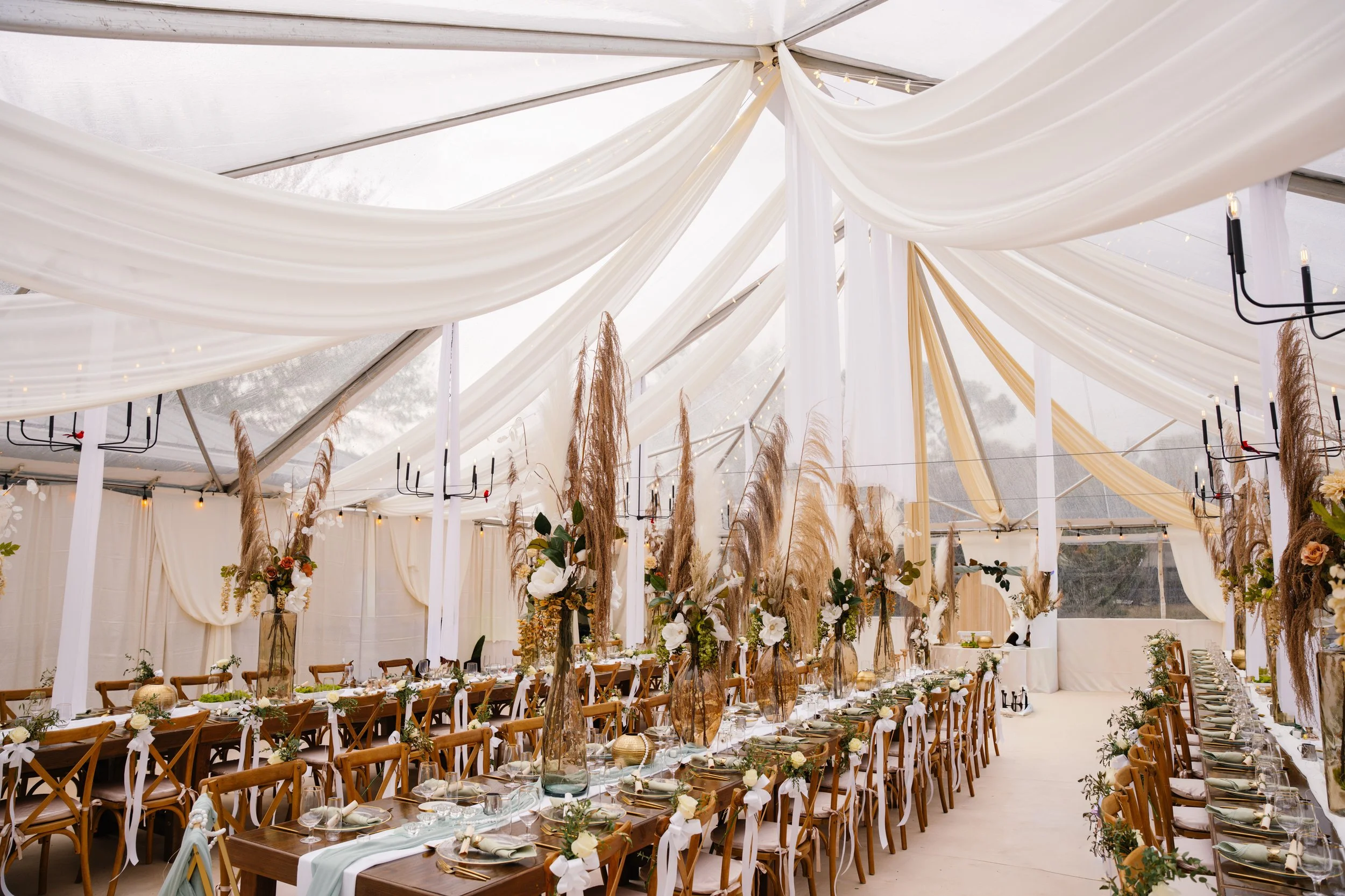 Wedding reception setup under white tent with elegant table design in South Florida