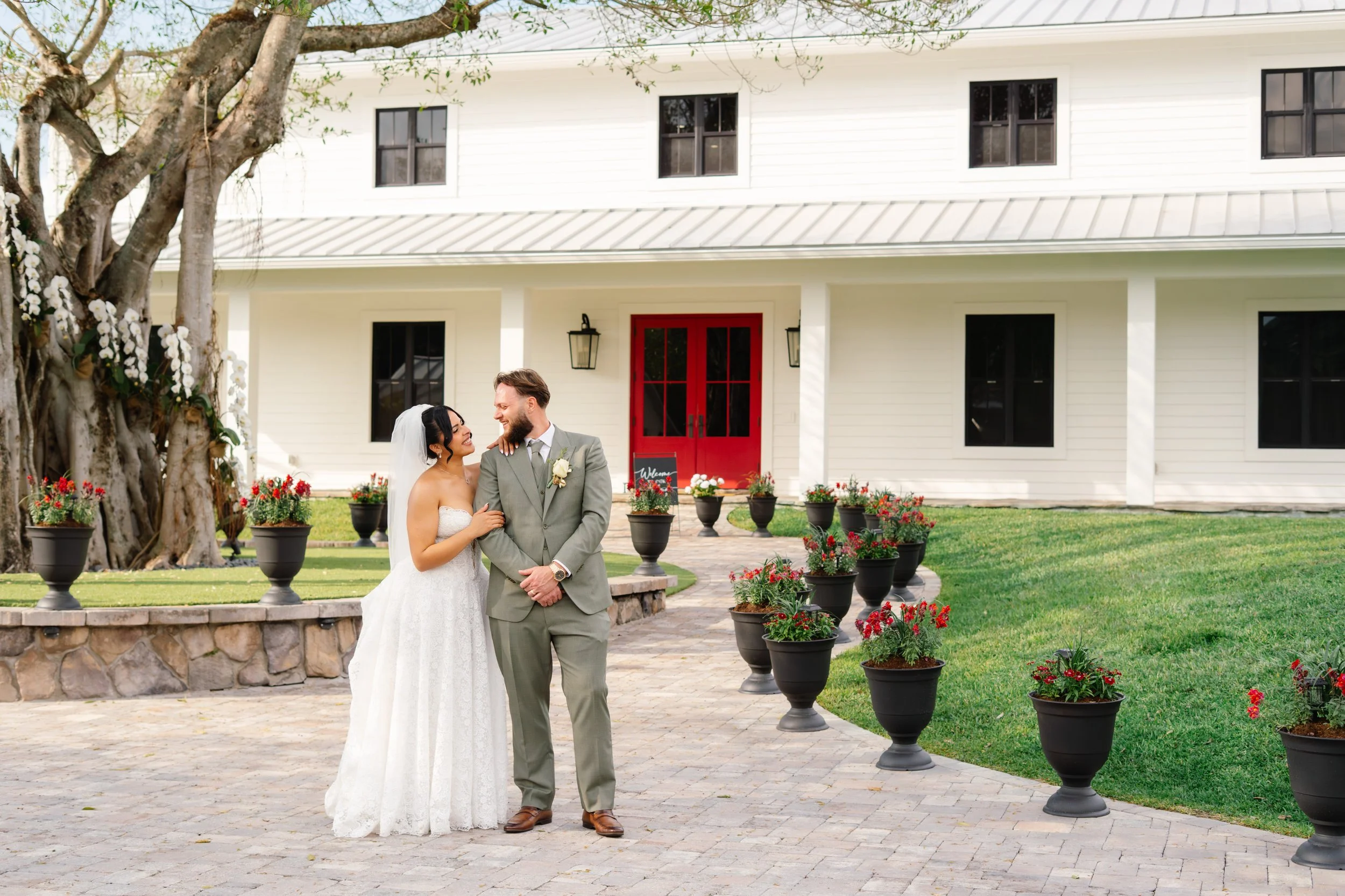 Bride and groom portrait in front of elegant venue building during South Florida wedding