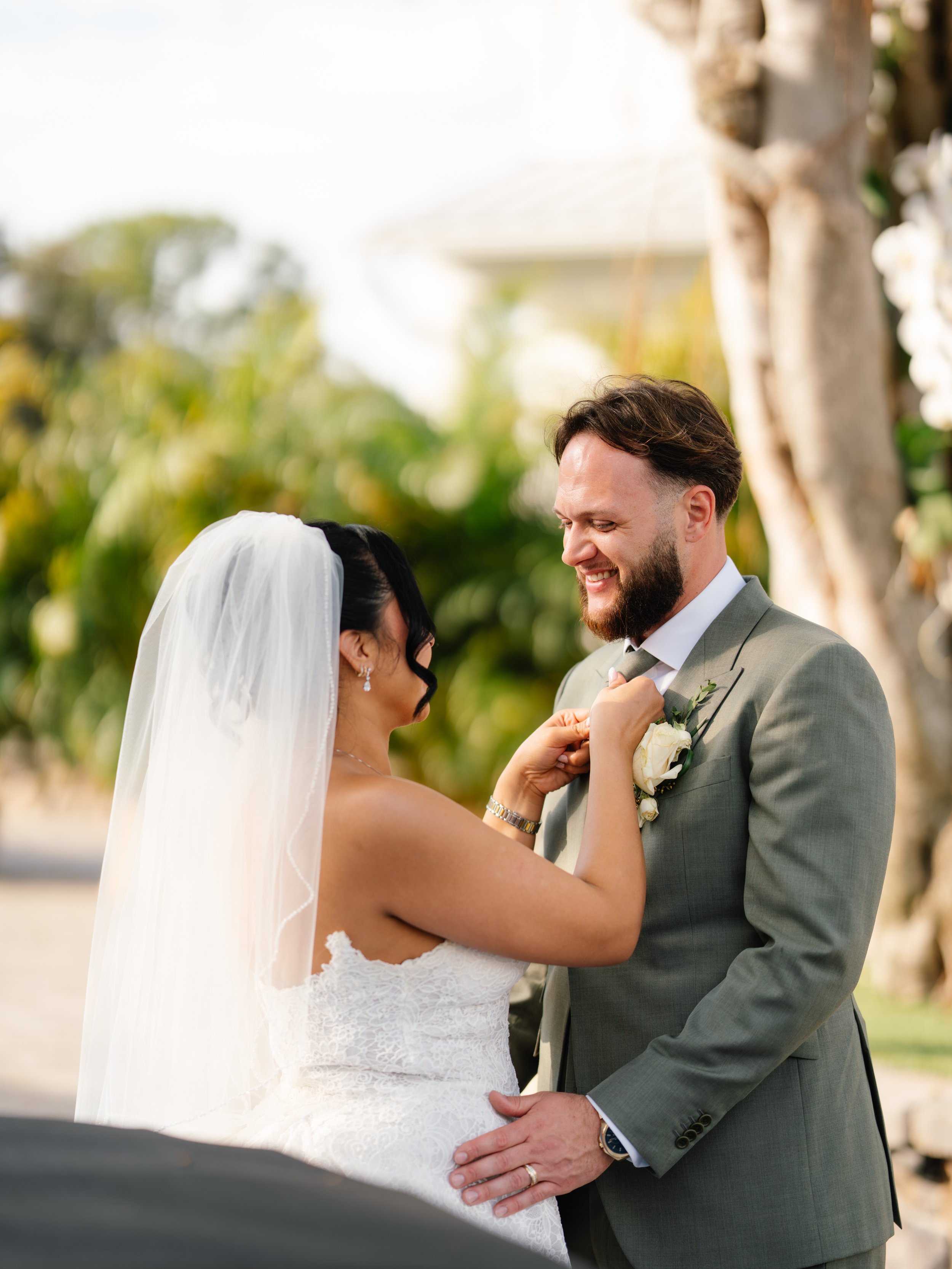 Groom laughing with bride during candid wedding portrait moment in South Florida