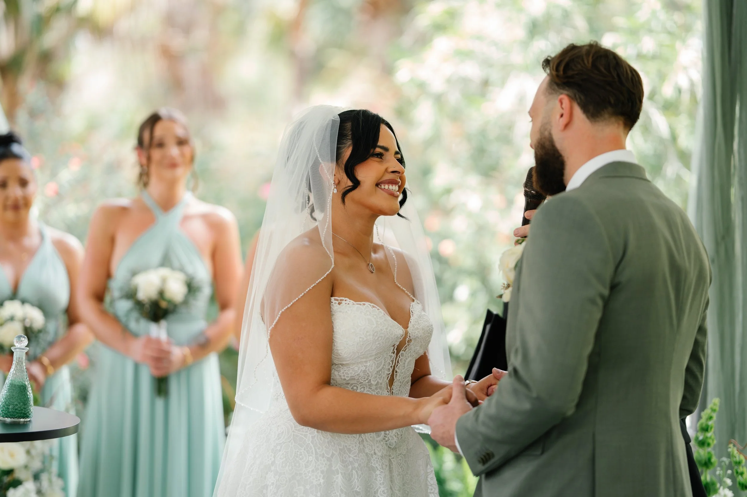 Bride smiling during emotional wedding vows in South Florida outdoor ceremony