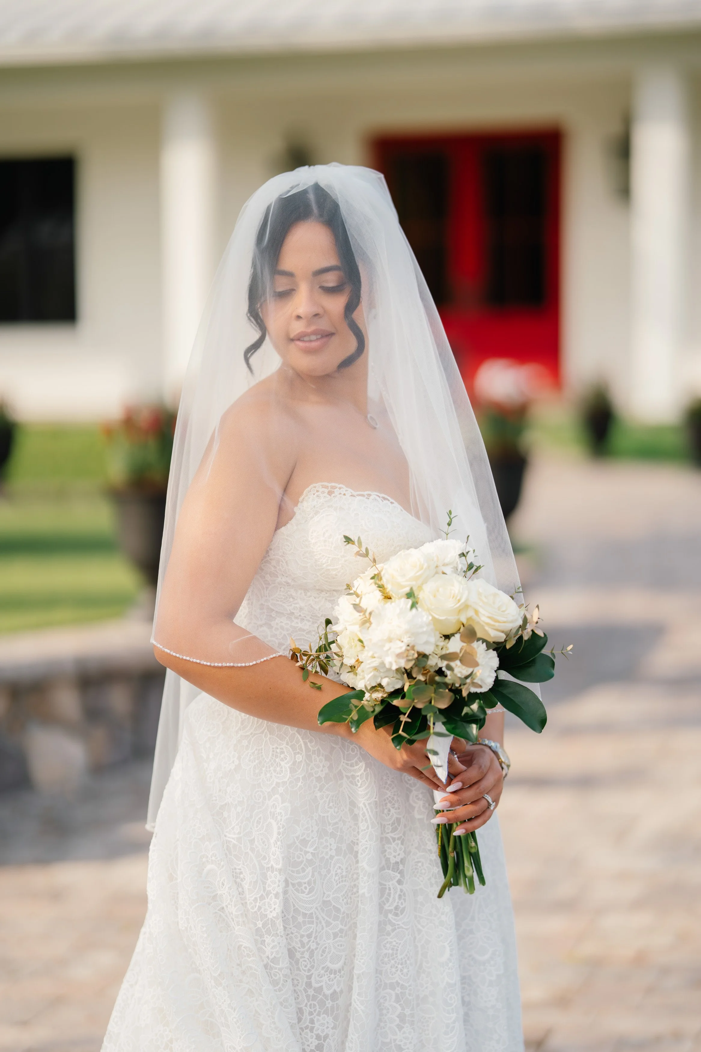 Bride and groom portrait in front of elegant venue building during South Florida wedding
