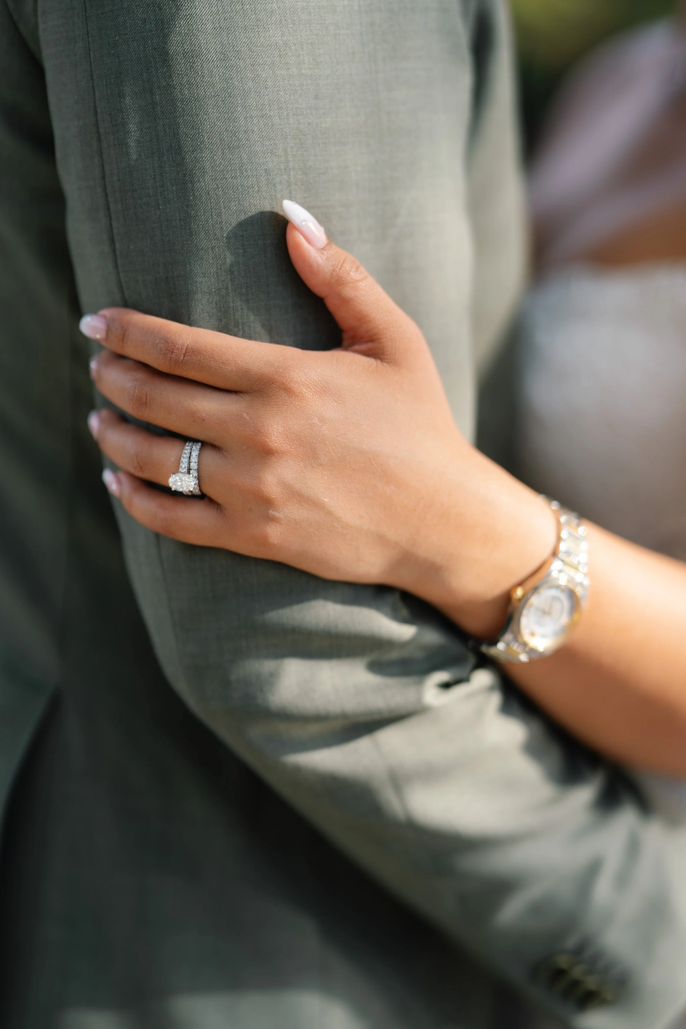 Close-up of bride’s hand resting on groom’s suit showing wedding ring during South Florida wedding