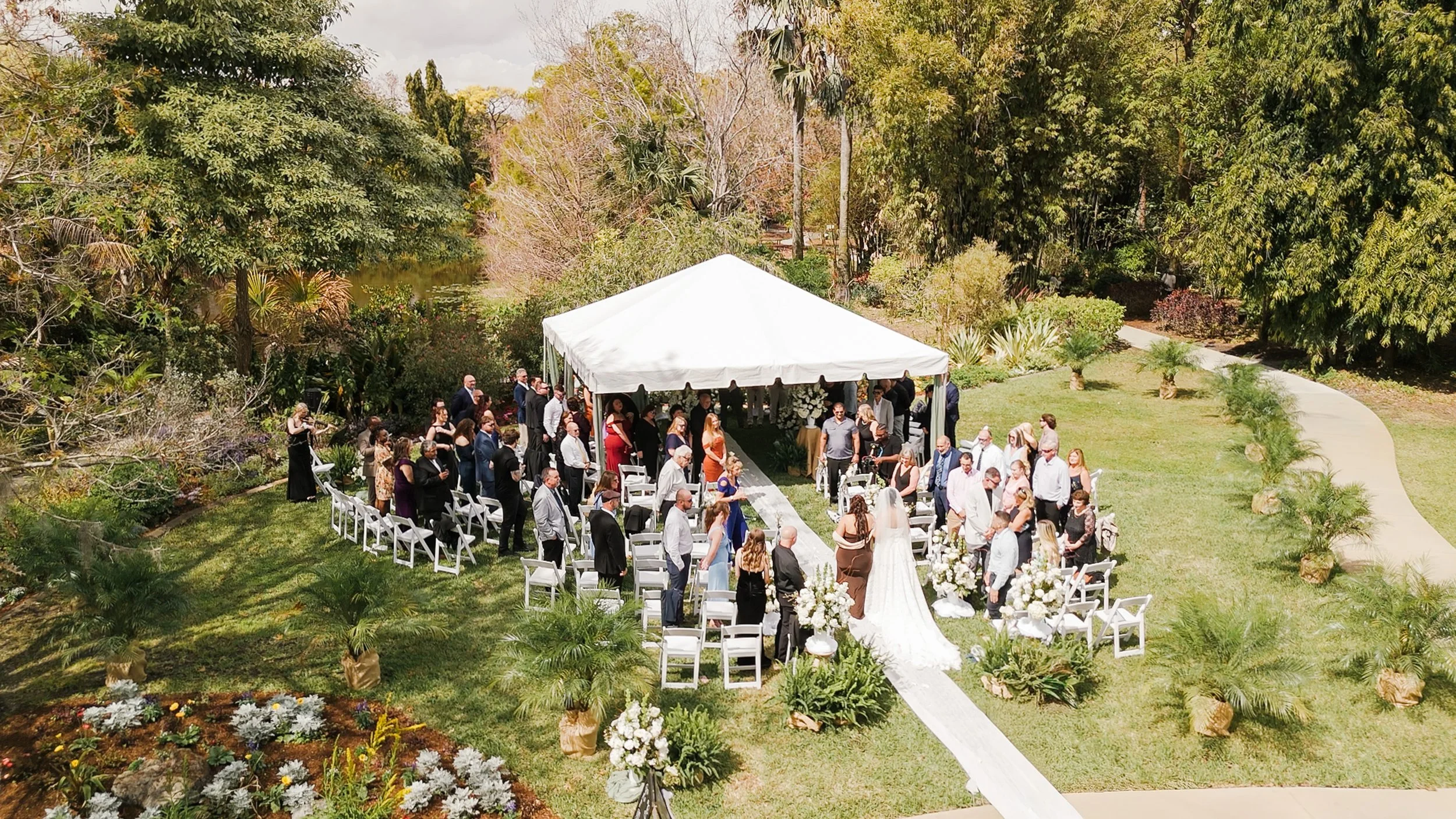 Wedding Ceremony at Mounts Botanical Garden in West Palm Beach with outdoor garden setting and elegant decor. 