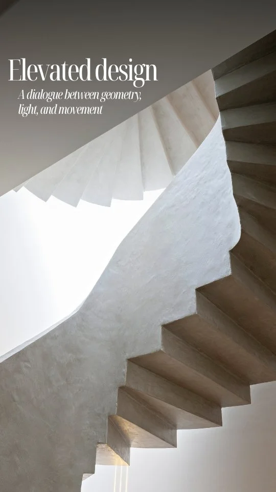 Interior view of a modern spiral staircase with a smooth concrete finish, showcasing an elevated design with a focus on geometry and light.