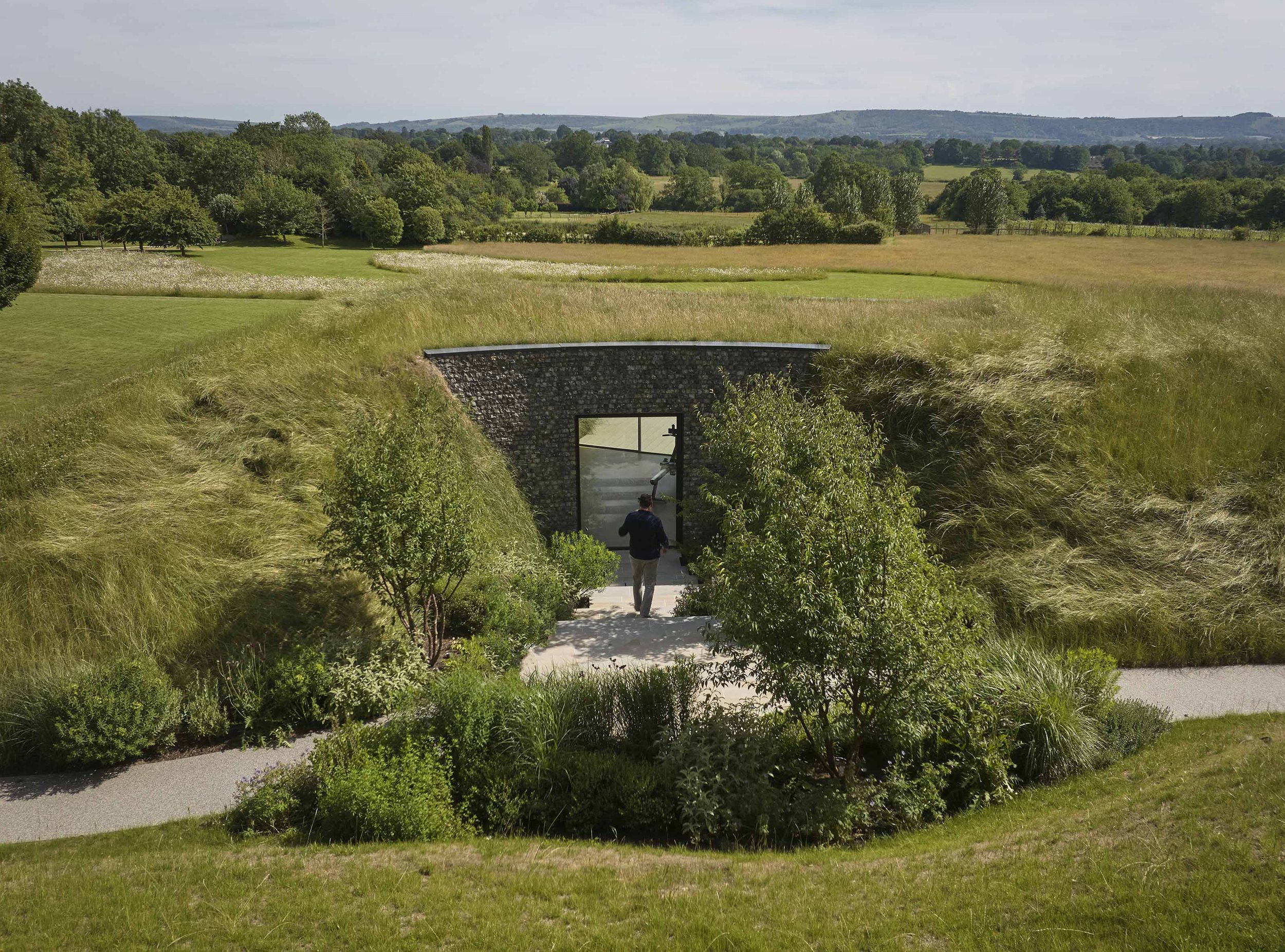 flint building carved into the south downs landscape with living roof