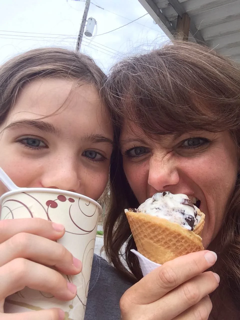 Rebecca and her daughter enjoying snacks outside at the Washington County Agricultural Fair.