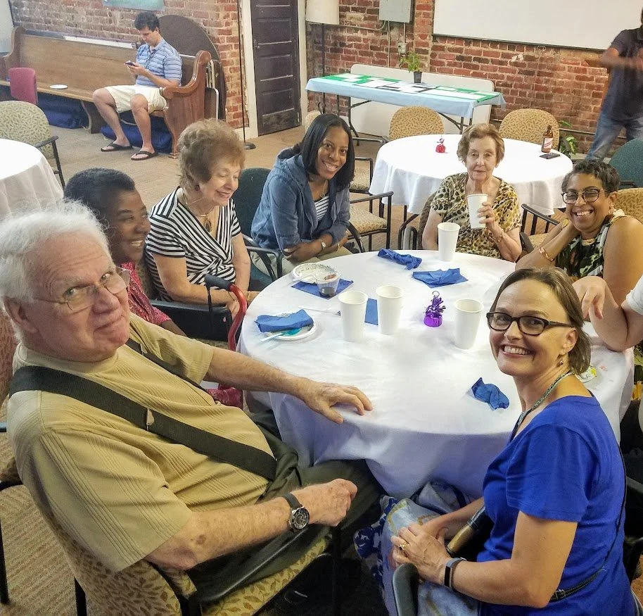 several people are sitting around a round table