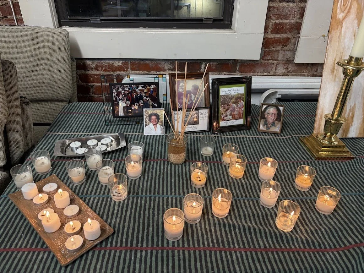 candles and framed photos on a table