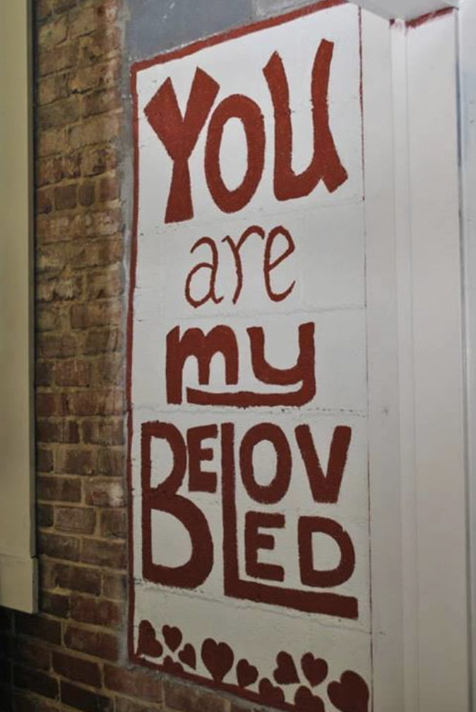 a white painted sign that reads you are my beloved